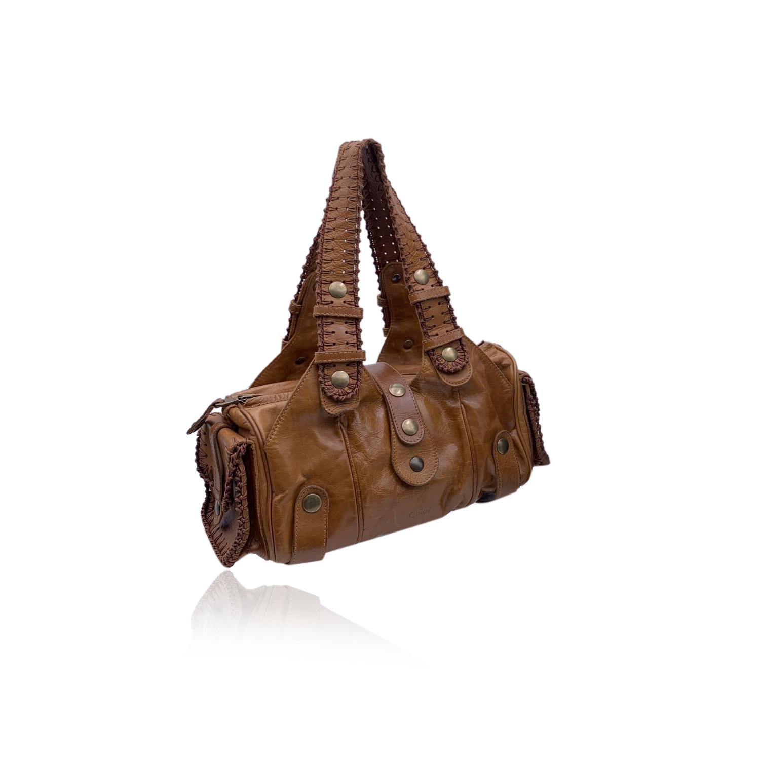 Beautiful CHLOE 'Silverado Bag' crafted in distressed genuine leather in a tan beige color. Western style. 2 side pockets and 2 exterior open compartments. Beige lining. Upper zipper closure. 1 side zip pocket inside. 'CHLOE - Made in italy'