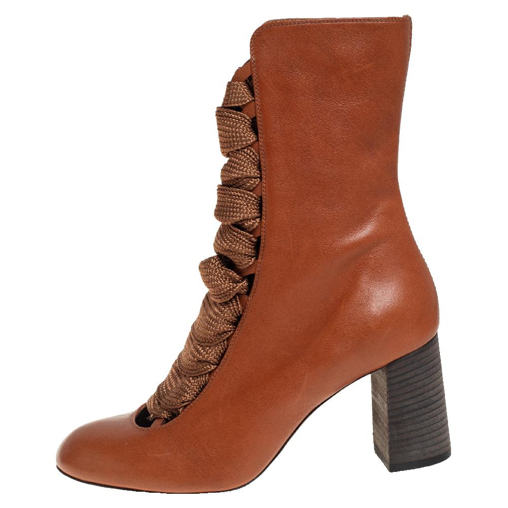 Chloé's tan leather Harper boots fasten with lace-up ribbons that exude a feminine Victorian appeal. They have round toes and are finished with stacked block heels, making them easy to wear from day to night.

