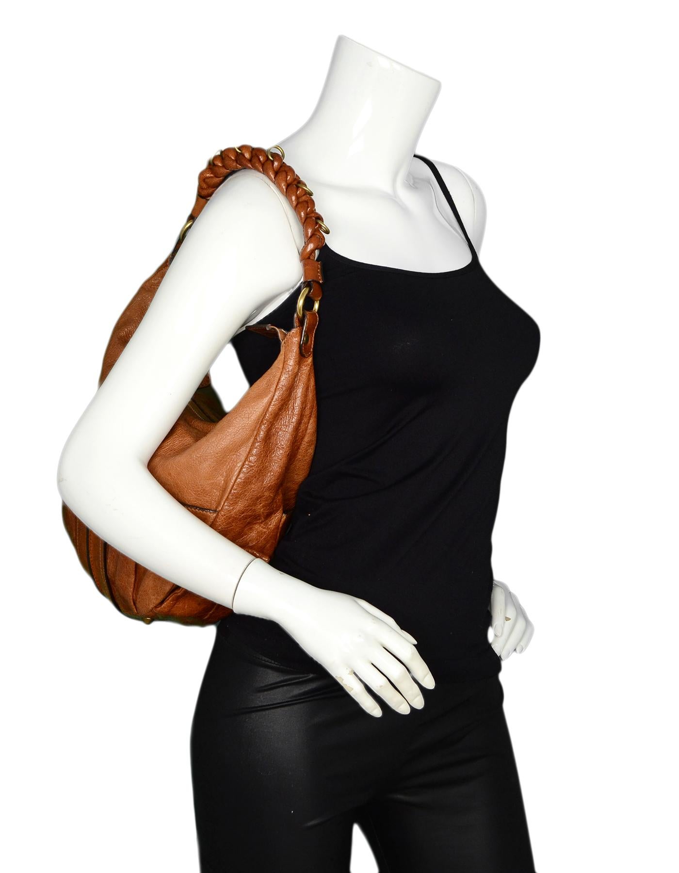 Chloe Tan Leather Heloise Hobo Bag w/ Braided Shoulder Strap

Made In: Italy
Color: Tan
Hardware: Antique goldtone hardware
Materials: Leather
Lining: Beige textile lining
Closure/Opening: Top zip
Exterior Pockets: Two slit pockets
Interior Pockets: