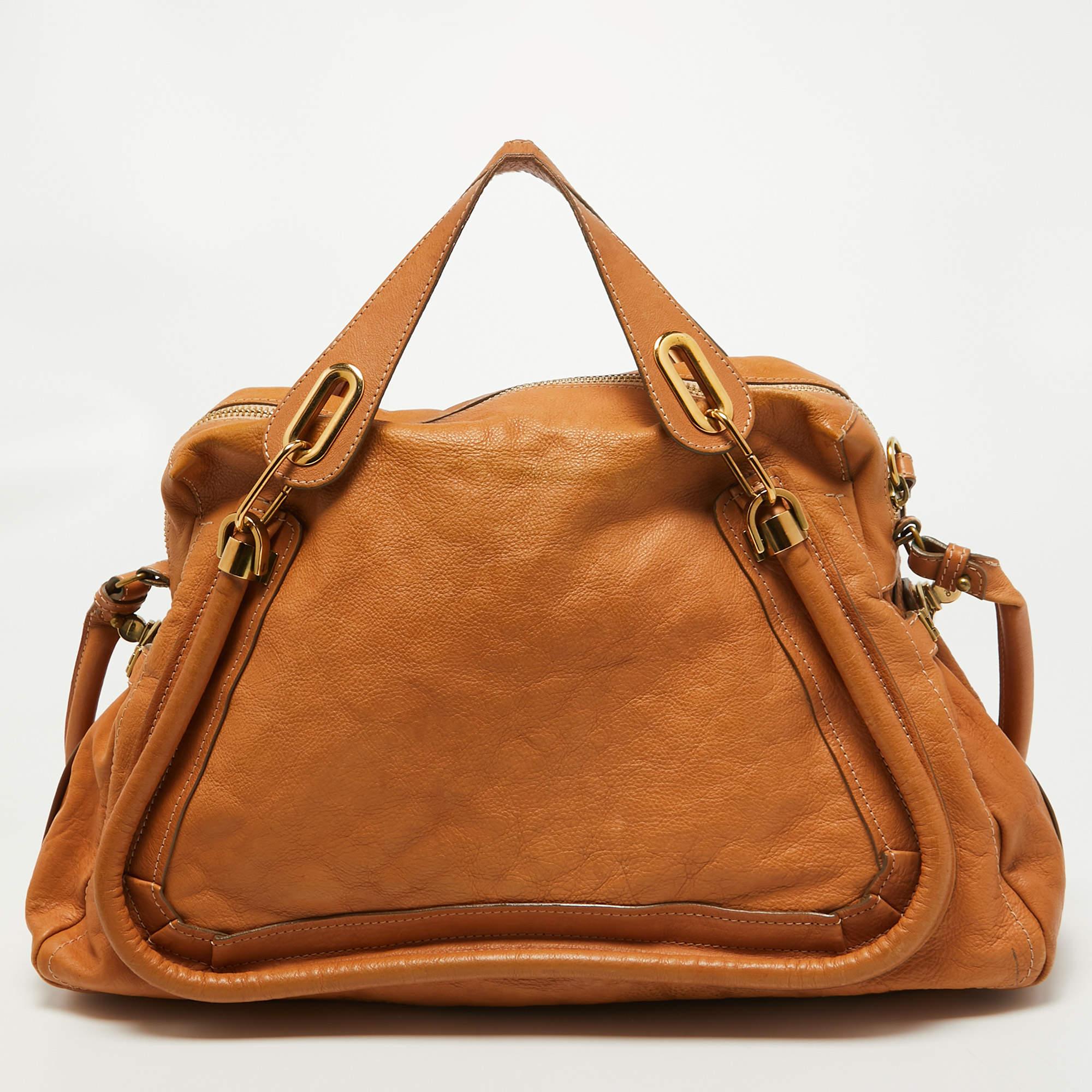 Experience fine craftsmanship with this immaculately designed shoulder bag. It has comfortable handles, notable details, and a lined interior.

