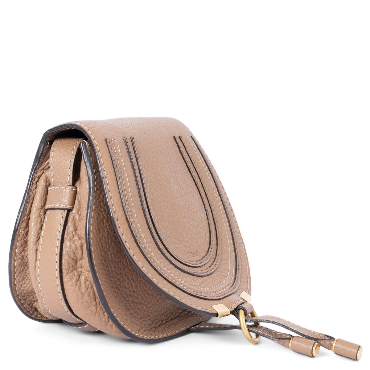 100% authentic Chloé Marcie Mini shoulder bag in brown grained leather. The design features a adjustable shoulder-strap, slot-tab fastening and is lined olive green canvas with an open pocket against the back. Has been carried and is in excellent