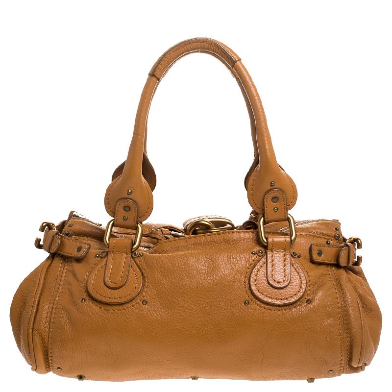 This Chloe Paddington satchel is built to assist your impeccable style on all days. Gold-tone hardware with a chunky lock on the front easily attracts all the attention. The tan leather has an interesting texture while the canvas interior is sized