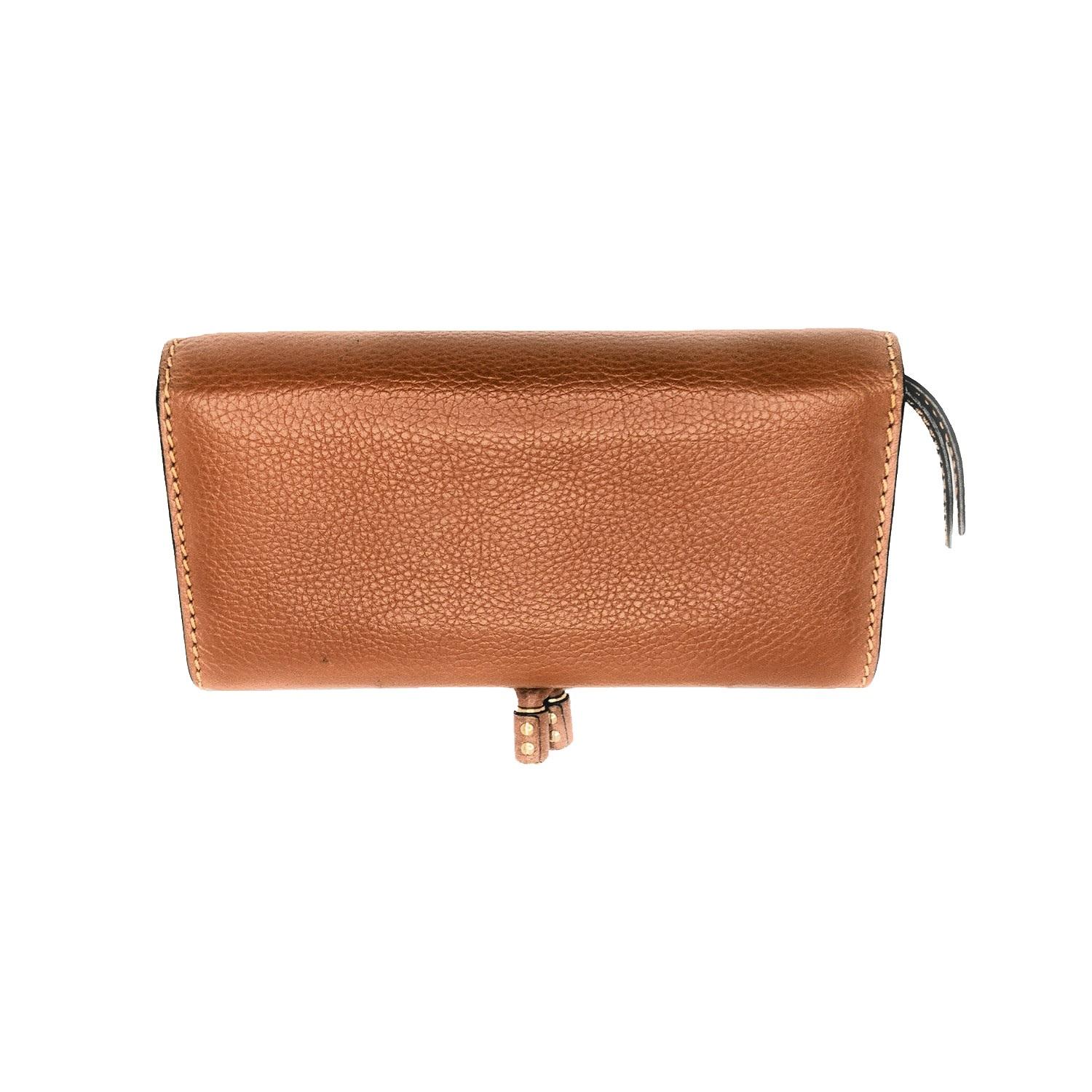 Tan leather Chloé Marcie continental wallet with gold-tone hardware, beige leather lining, three interior compartments; one with zip closure, single slit pocket at interior, twelve card slots and snap closure at front flap. Retail price is