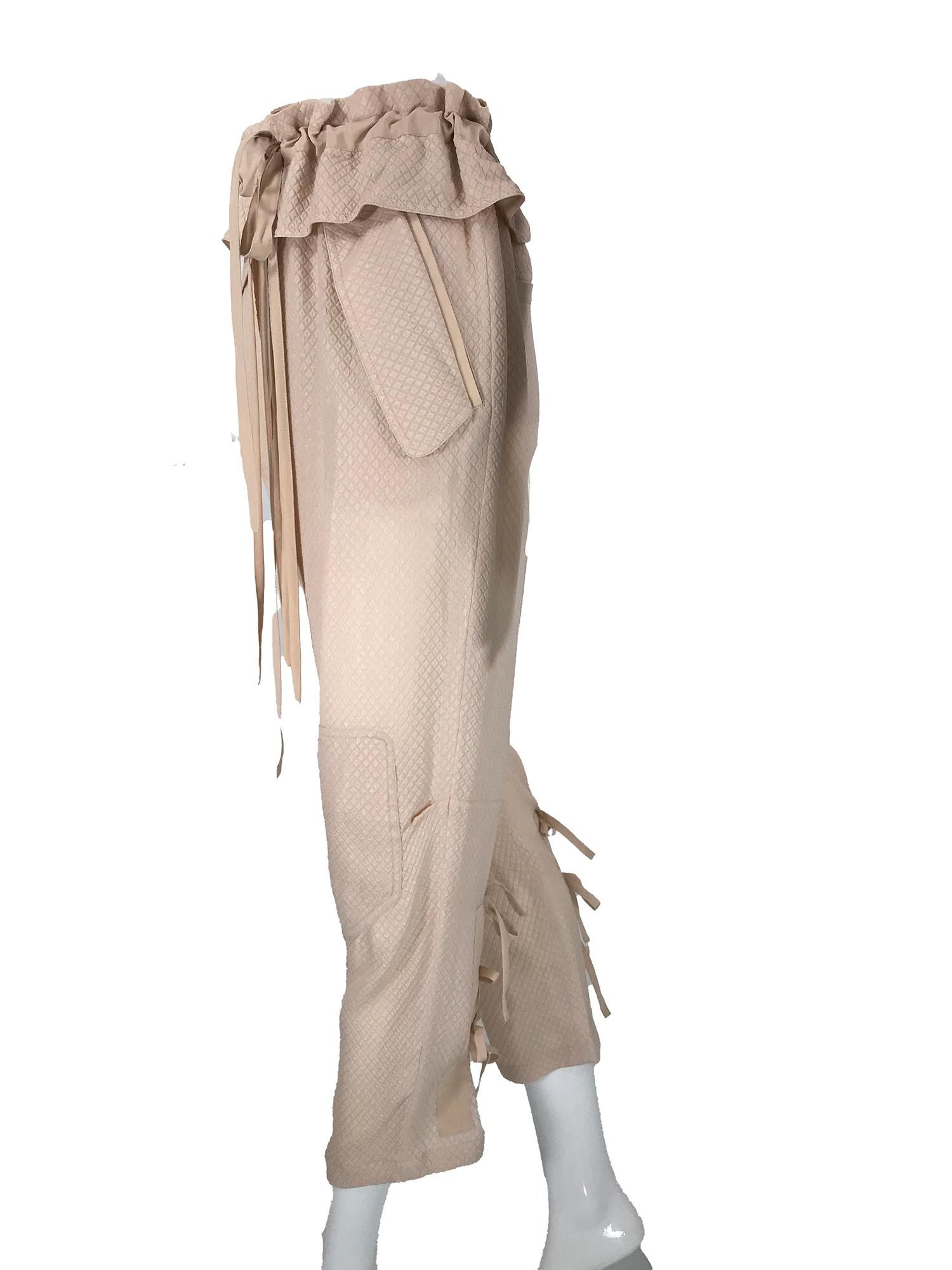 Chloe taupe diamond weave silk paper bag waist, gathered tie leg trouser.
Peachy/taupe textured diamond weave silk these trousers bridge the gap between dress and casual. Paper bag waist ties with silk crepe ties, there is a ruffle at the waist and