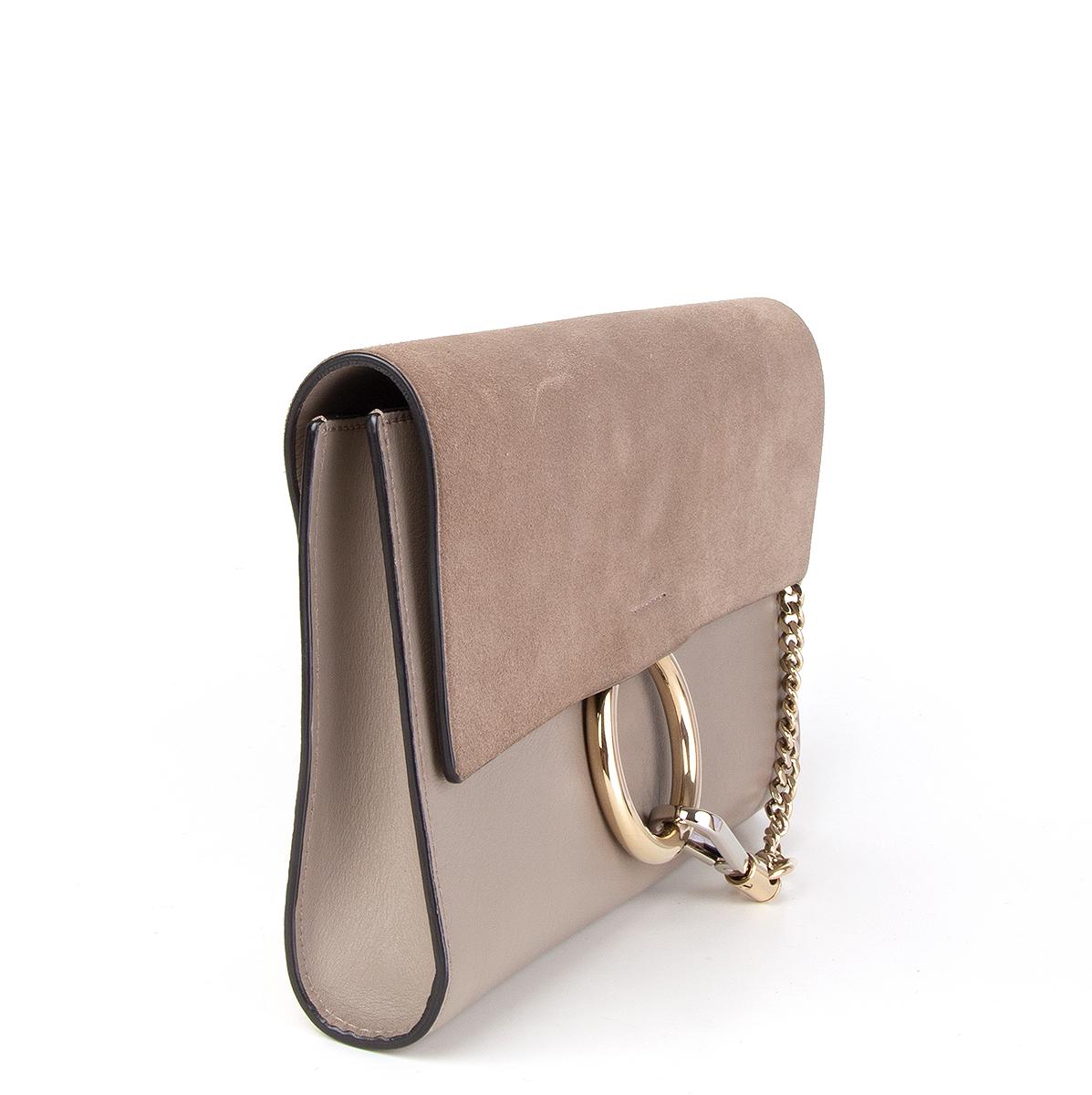 Chloé ' Faye' clutch in motty grey calfskin and suede flap featuring light gold-tone and silver hardware. Opens with a magnetic closure and is lined in grey suede with one open pocket against the back. Has been carried with some faint discoloration