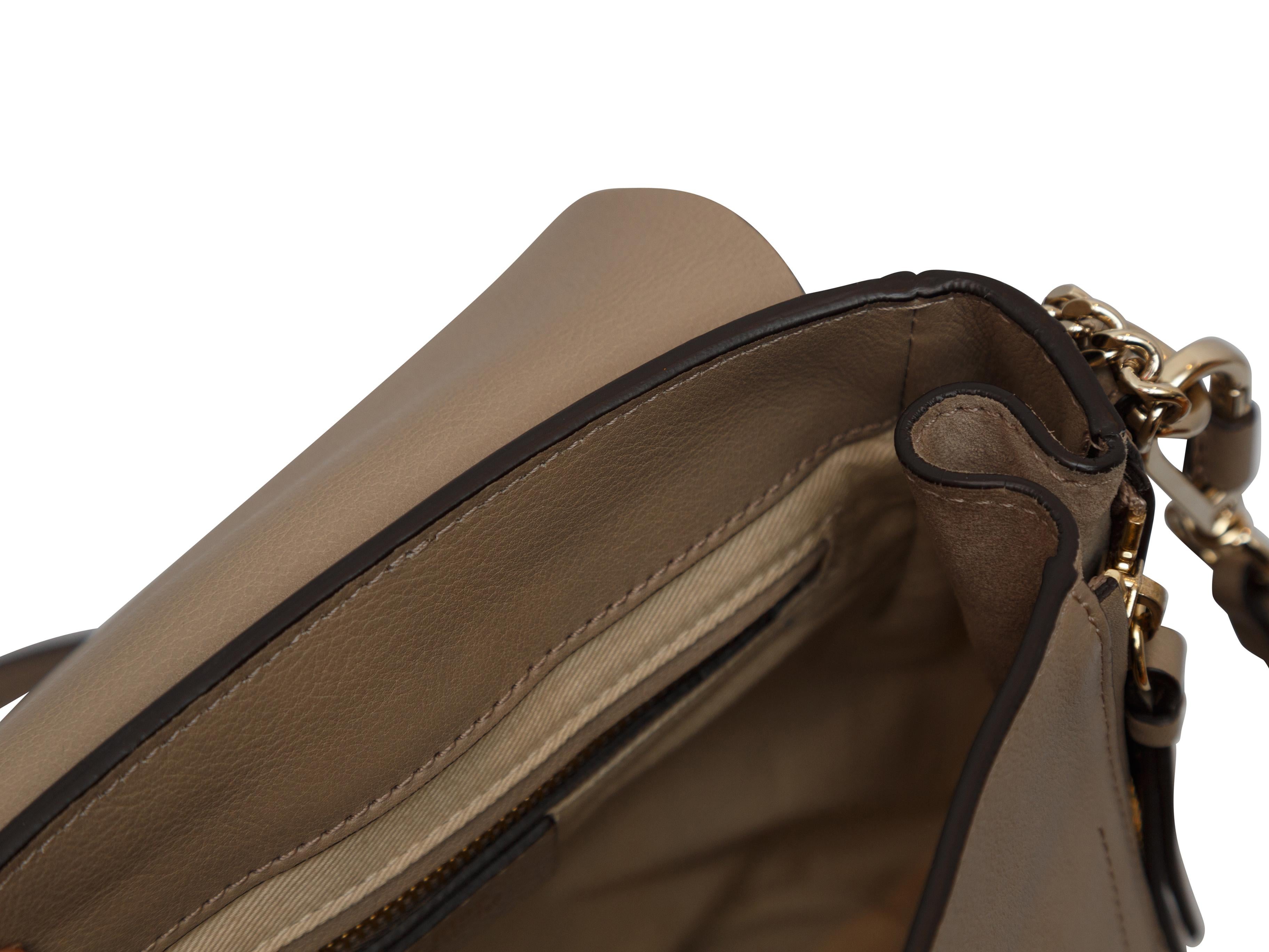 Product details: Taupe leather Medium Faye backpack by Chloe. Interior zip pocket. Gold-tone hardware. Adjustable shoulder straps. 8.5