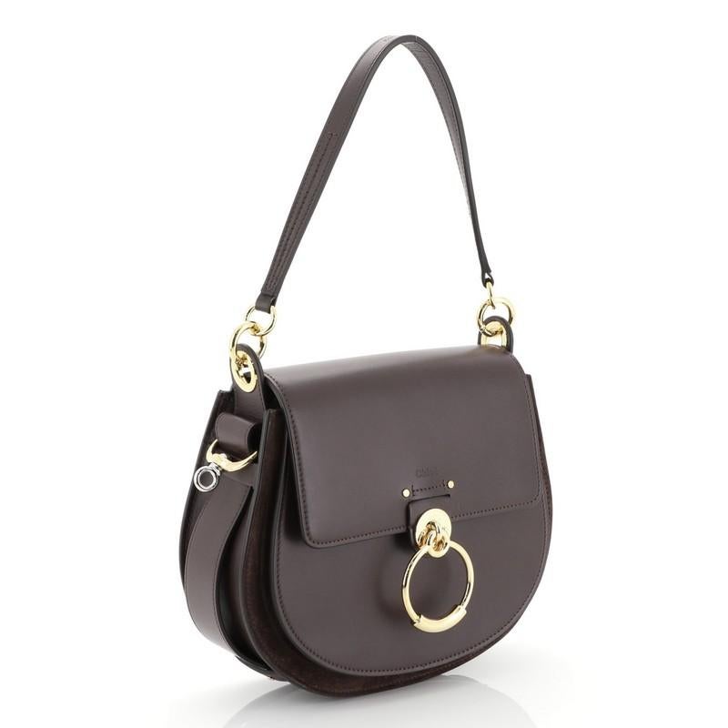 This Chloe Tess Bag Leather Large, crafted from purple leather and suede, features flat leather handle with rings, slip pocket under flap, ring ornament detail, and gold-tone hardware. Its magnetic snap closure opens to a neutral fabric interior.