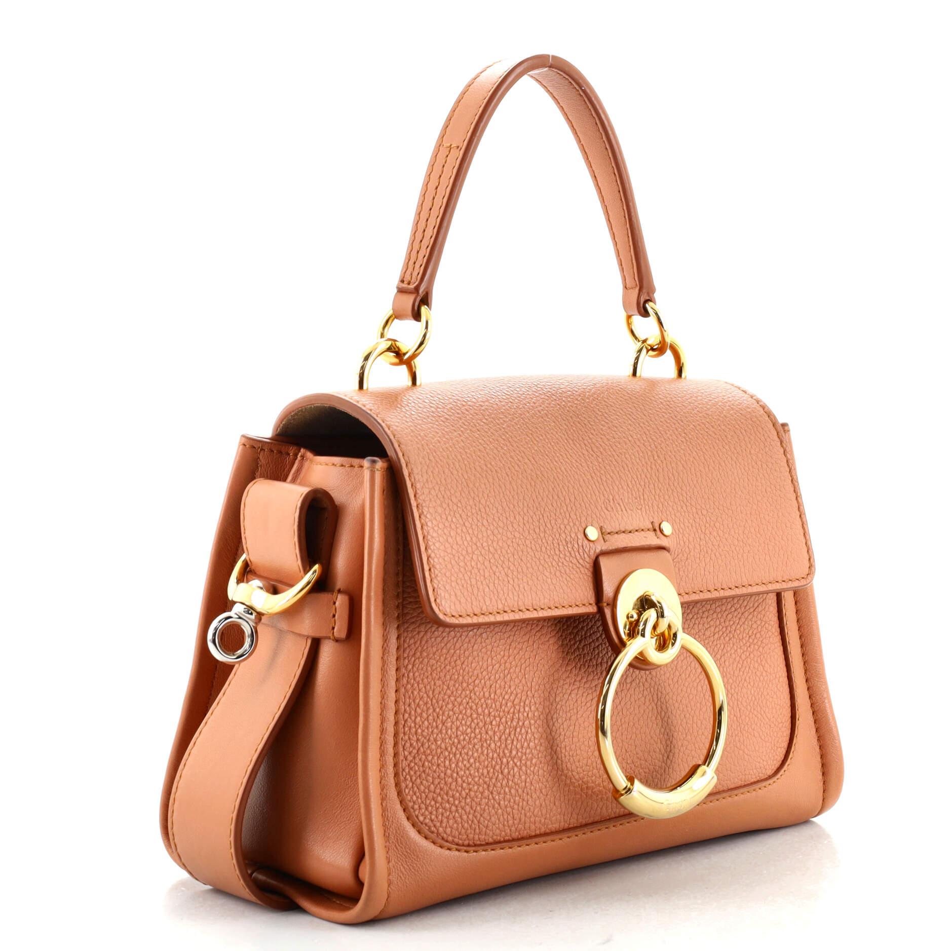Condition: Good. Wear on base corners, light creasing on exterior and strap, darkening and wear on opening corners, flap and rear pocket edge and underneath flap. Minor cracking on strap wax edges, moderate wear, darkening and stains in interior,