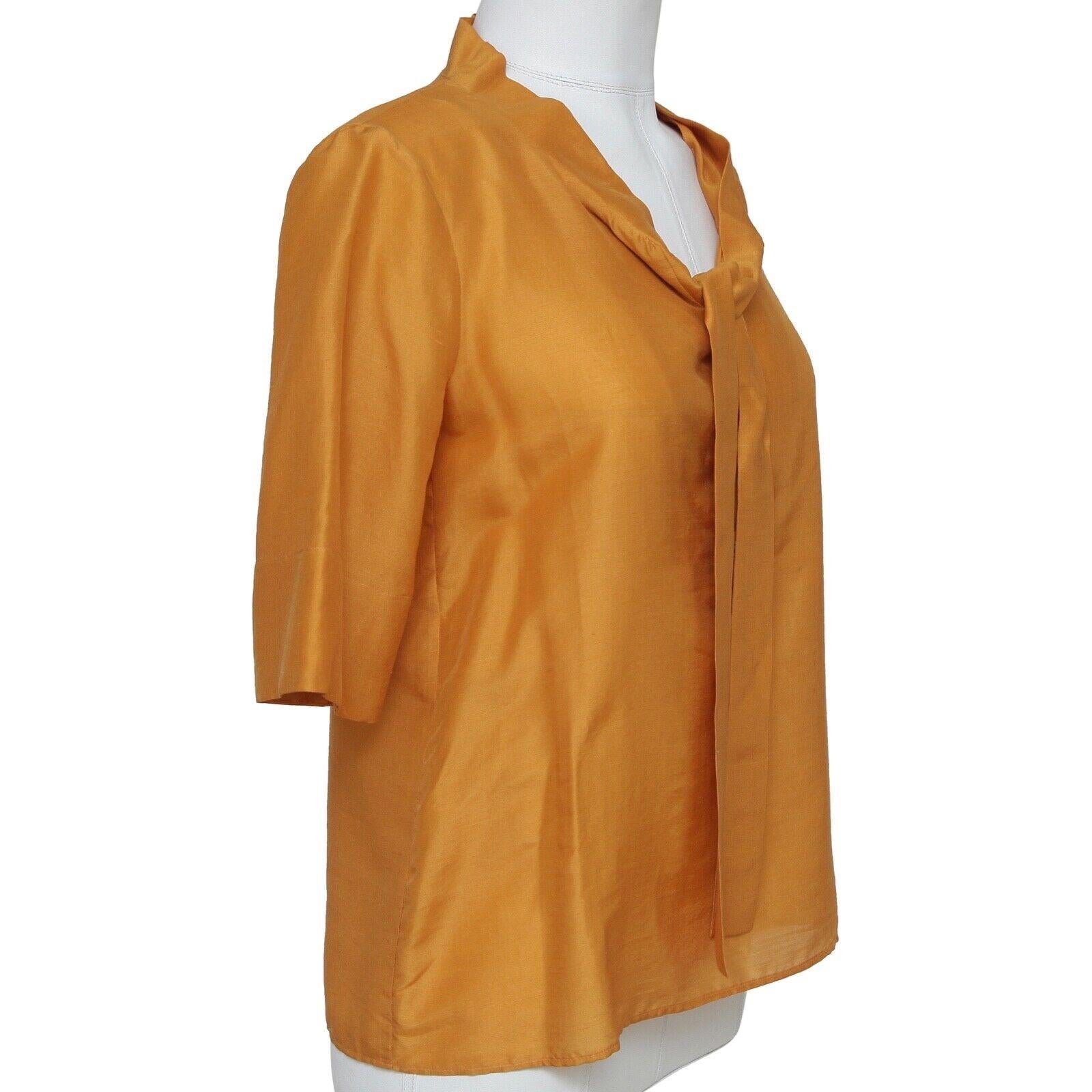GUARANTEED AUTHENTIC CHLOE FALL 2007 MARIGOLD SILK BLEND SHORT SLEEVE BLOUSE

 

Design:
- Short sleeve marigold (yellow-orange) silk blend blouse.
- Scoop neck, with tie accent.
- Buttons down back of blouse.
- Beautiful, lightweight year