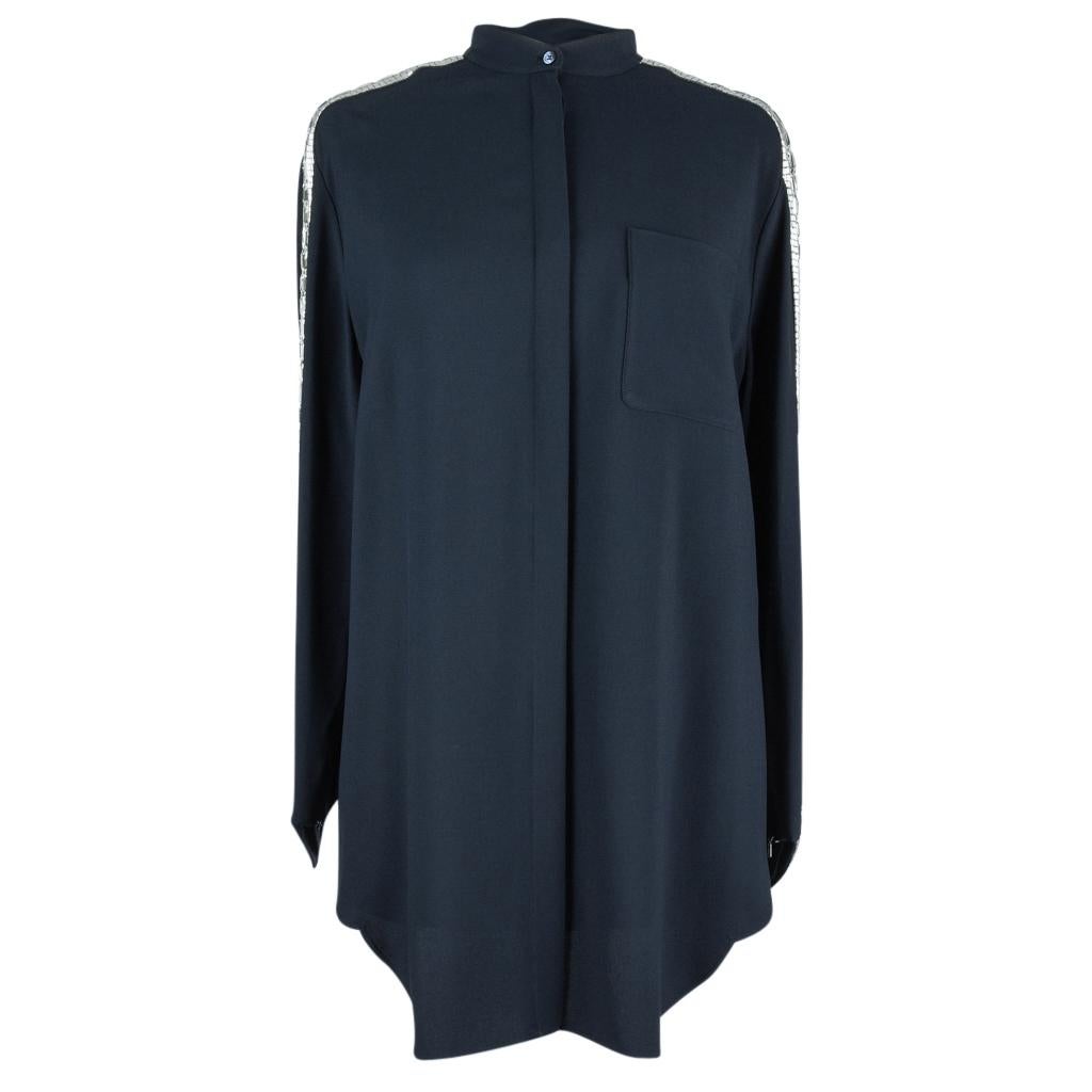 Guaranteed authentic Chloe blue tunic top with embellished sleeves. 
Navy tunic top with silver bugle and faceted beading along shoulder and sleeve.
Beading extends down sleeve to form a V at zippered cuff.
Mandarin collar.
Hidden button
