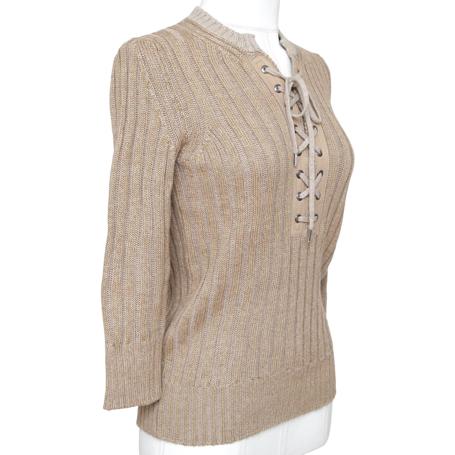 GUARANTEED AUTHENTIC CHLOE 2011 COLLECTION RIBBED LONG SLEEVE SWEATER LEATHER TRIM

Details:
• Very comfortable 3/4 sleeve ribbed sweater in a beige color.
• Henley style tie up front with leather trim.
• Long sleeves.
• Crew neck.

Material: 50%