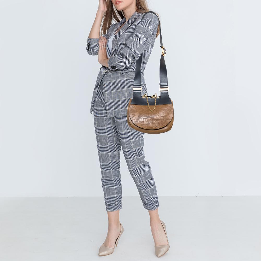 One of the most recognizable bags in the luxury world, Chloe's Drew bag was part of the label's fall/winter 2014 collection. This tricolored Drew carries a distinct saddle shape and minimal style detailing. This shoulder bag has been meticulously