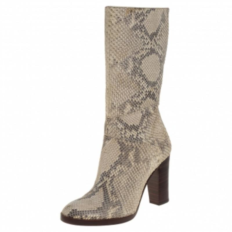 Create a striking look with these stunning boots from Chloé! Animal prints are timeless, and so are these boots. Crafted from python in dual tones, they feature round toes, zippers on the sides, and block heels for a comfortable walking experience.
