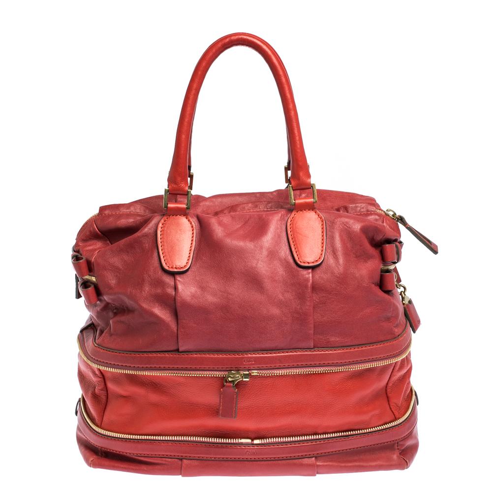 Featuring dual top handles, this red Chloe Andy satchel exudes just the right amount of sophistication. The bag features a leather exterior and a capacious Alcantara interior that is expandable.

Includes: Original Dustbag, Authenticity Card, Info