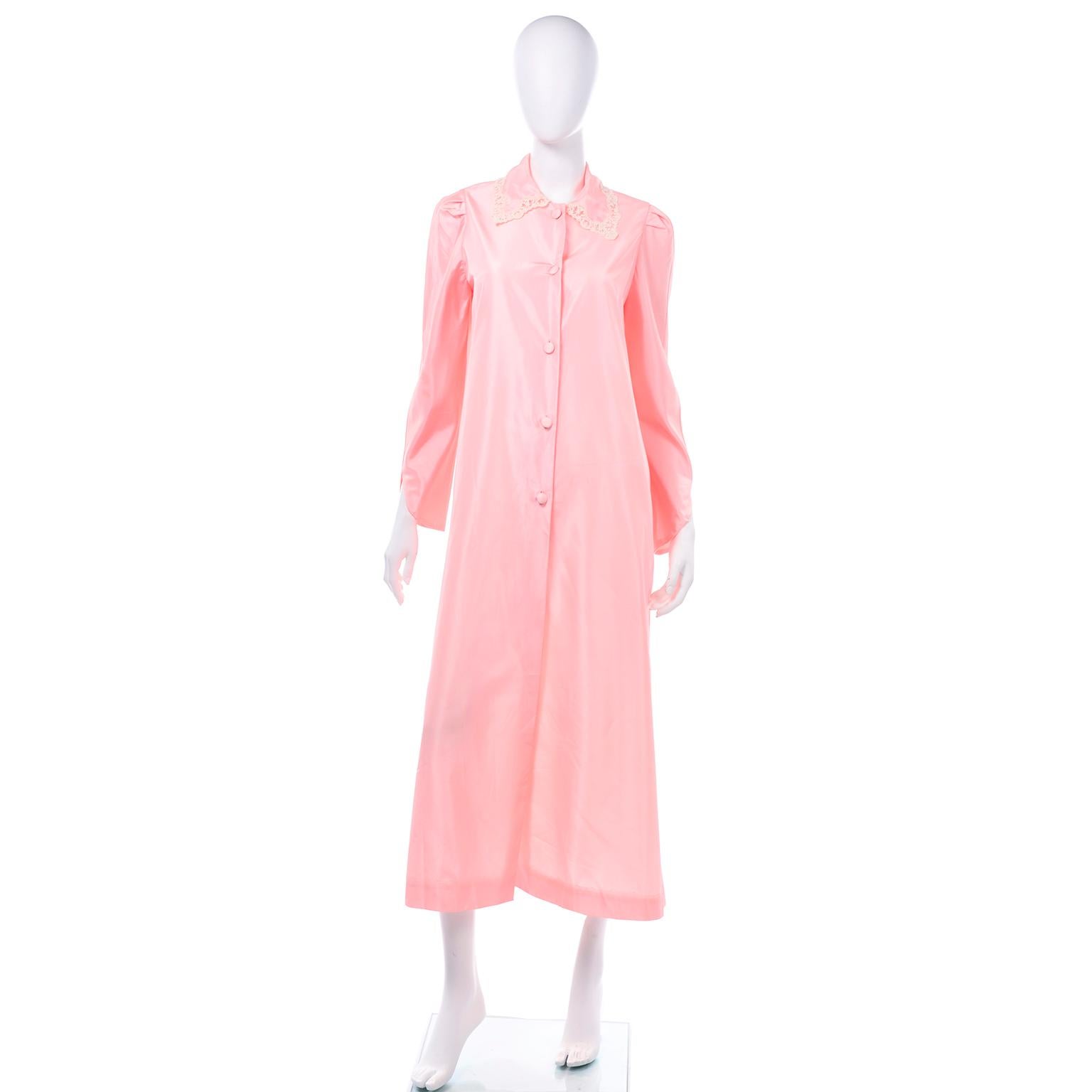 This is a really lovely vintage robe from Chloé in a pretty pink taffeta with lace trim. The sleeves are cut at an angle at the cuff and delicate cream lace trim is around the pointed collar. Ths housecoat is quite long and has fabric covered