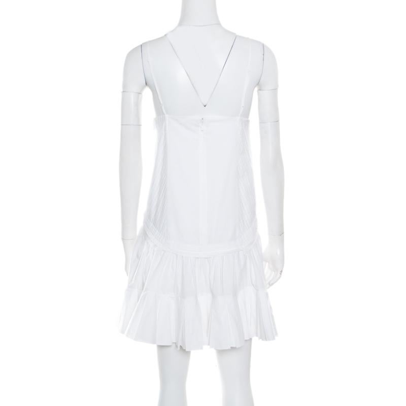 This flattering feminine dress from Chloe is sure to make you stand out! The white creation is made of 100% cotton and features blossoms embroidered on the bodice. It flaunts a plunging neckline, noodle straps and a pleated bottom silhouette. It