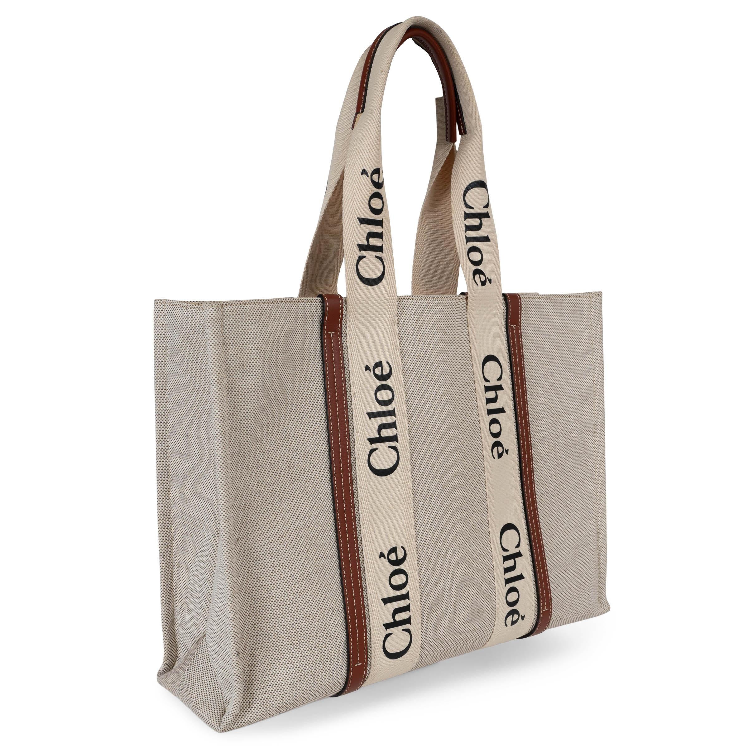 This 100% authentic Chloé Woody Large tote in white oatmeal canvas blends effortless elegance with everyday practicality. Accented with brown shiny leather trims and signature black and white logo ribbon handles, it embodies the brand’s modern yet