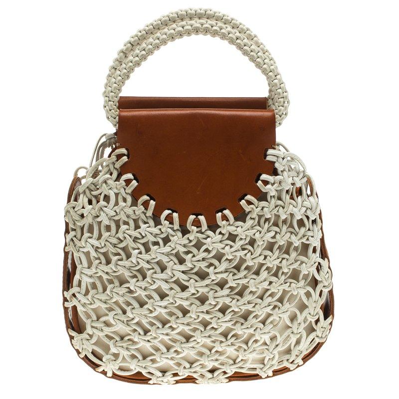Catch admiring glances when you swing this Bracelet bag by Chloe. Crafted from leather it comes with knot detailing and bracelet inspired dual handles. It has a spacious fabric lined interior capable of holding all your essentials. Well crafted and