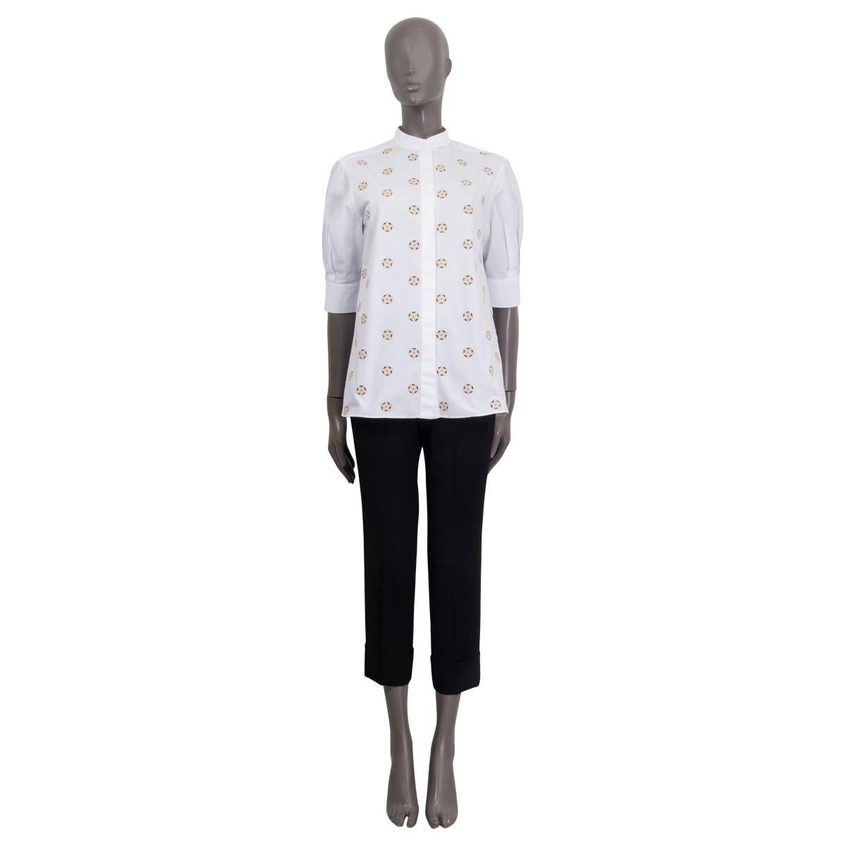 100% authentic Chloè blouse in white and beige cotton (100%). Features dots with broderie anglaise blooms, puffed sleeves and buttoned cuffs. Opens with eight buttons on the front. Unlined. Has been worn and is in excellent