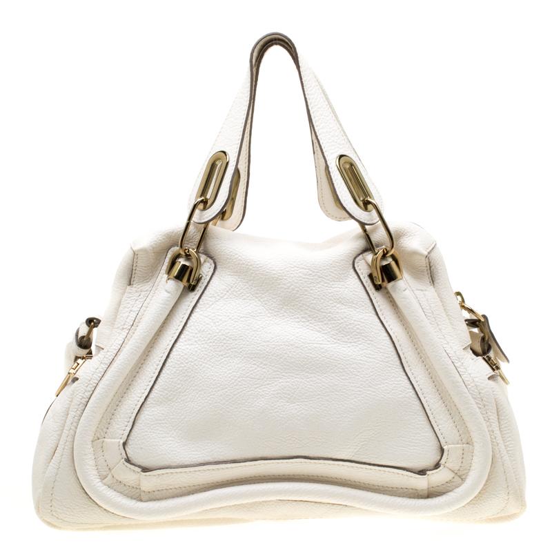 Perfect to flaunt and built to last, this shoulder bag by Chloe is a worthy buy. Crafted with leather, this bag has a spacious fabric-lined interior that houses a zip pocket. With two top handles accentuated with gold-tone hardware, a detachable