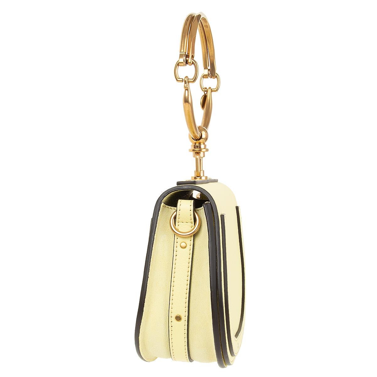 Chloe 'Small Nile Bracelet' bag in citrus yellow grained calfskin and suede featuring antique gold-tone hardware. Open pocket on the outside back. Detachable and adjustable shoulder strap. Closes with magnetic-snap under the flap. Lined in taupe