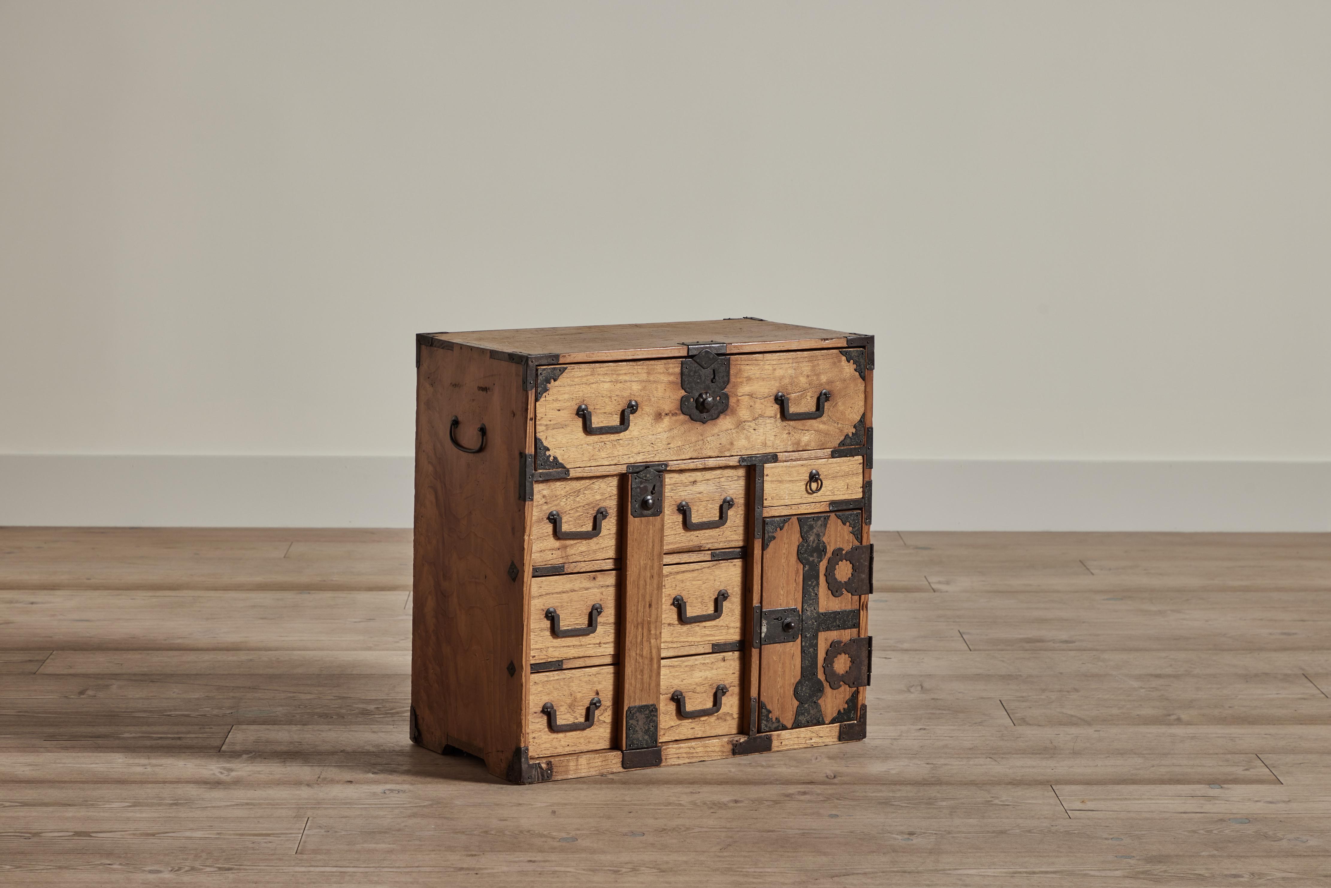 Japanese cho dansu merchant’s storage chest made of kiri wood and iron hardware. Wear on wood and irony hardware is consistent with age and use. 