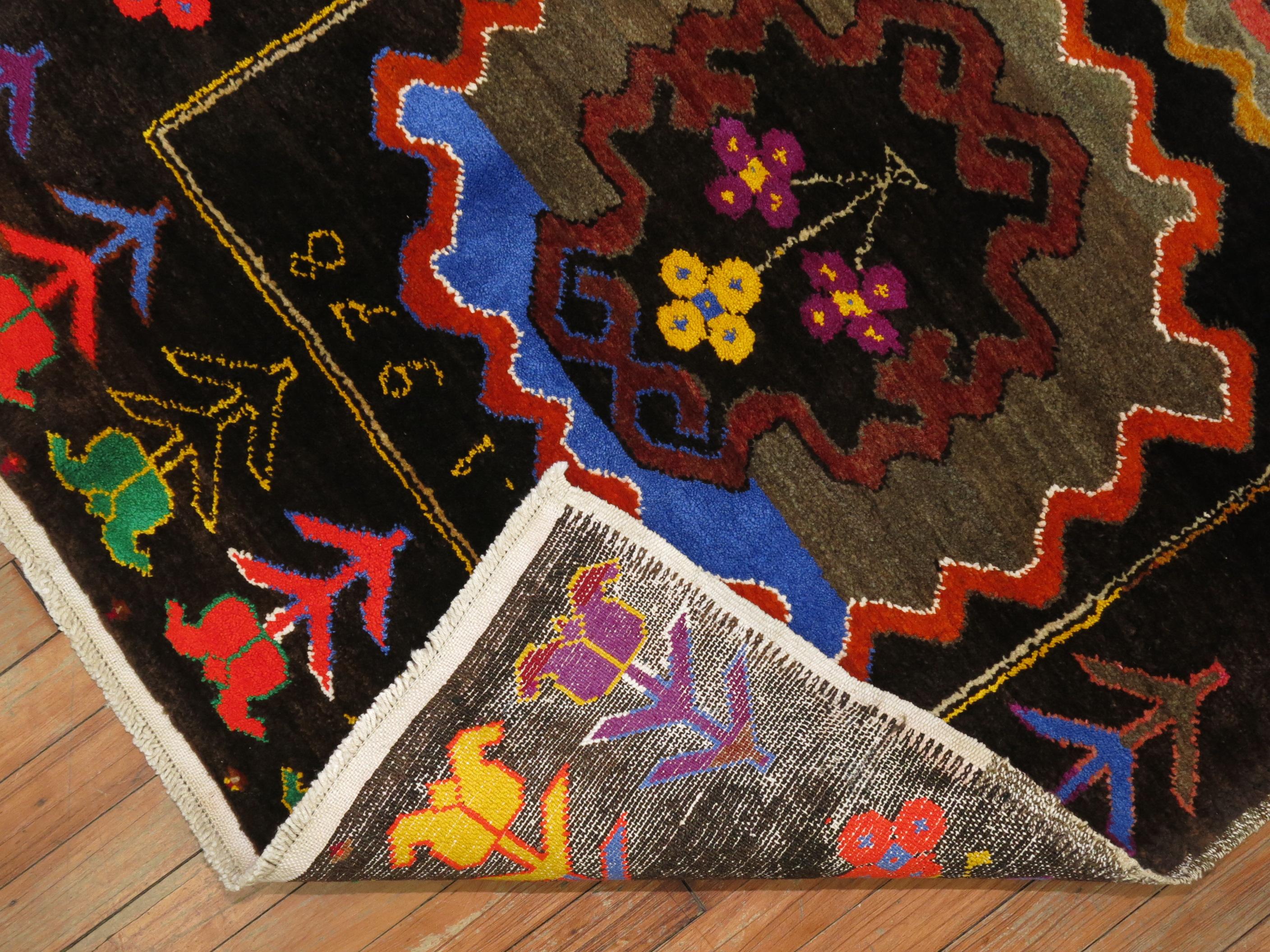An eclectic Turkish Anatolian runner with a flashy array of electric colors. 5 medallions occupy a chocolate brown ground, bright coral, orange, green, yellow, blue and purple accents. 

 Measures: 3'3