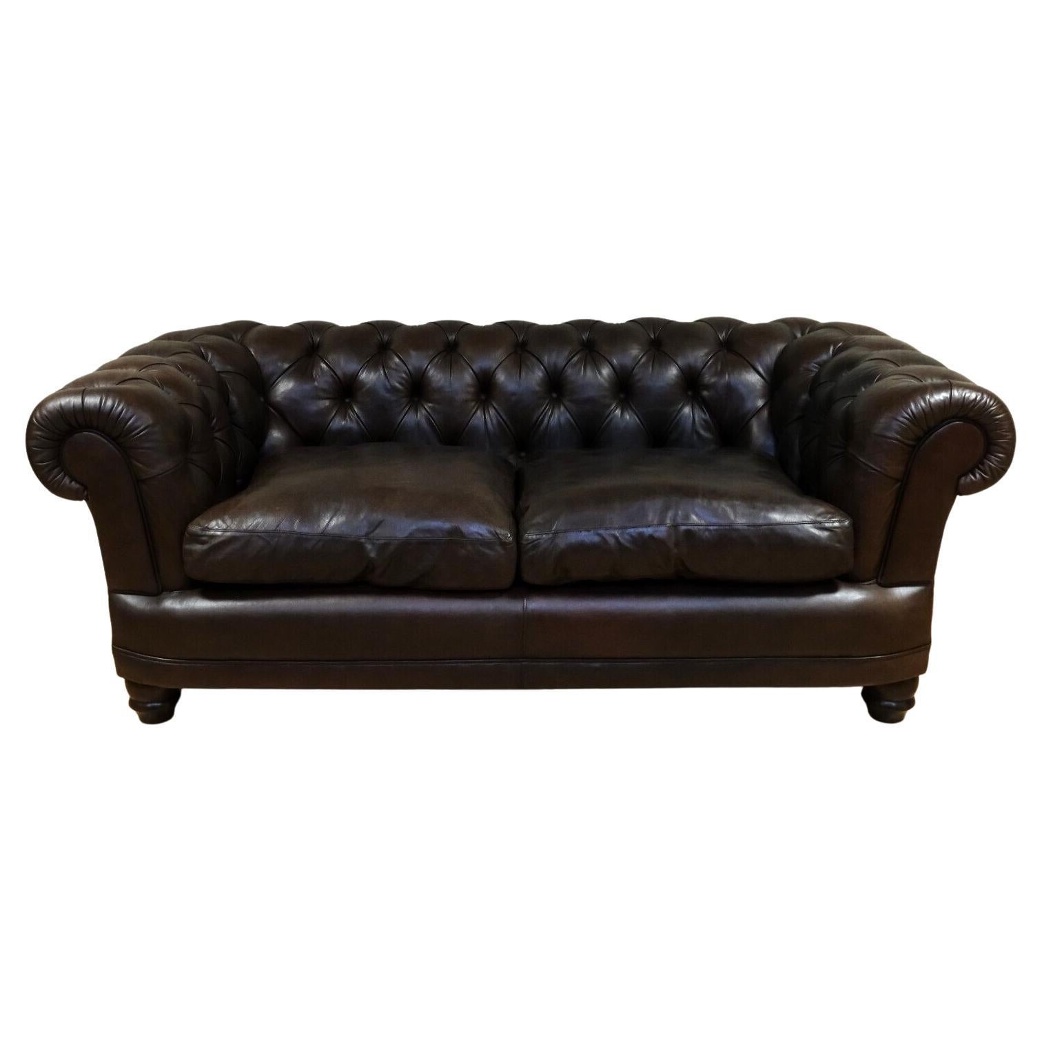 We are delighted to offer for sale this lovely Chesterfield two seater brown leather sofa with classic arms and feather filling.

This sofa is a classic and timeless piece of furniture. This piece features a distinctive rolled back and arms that