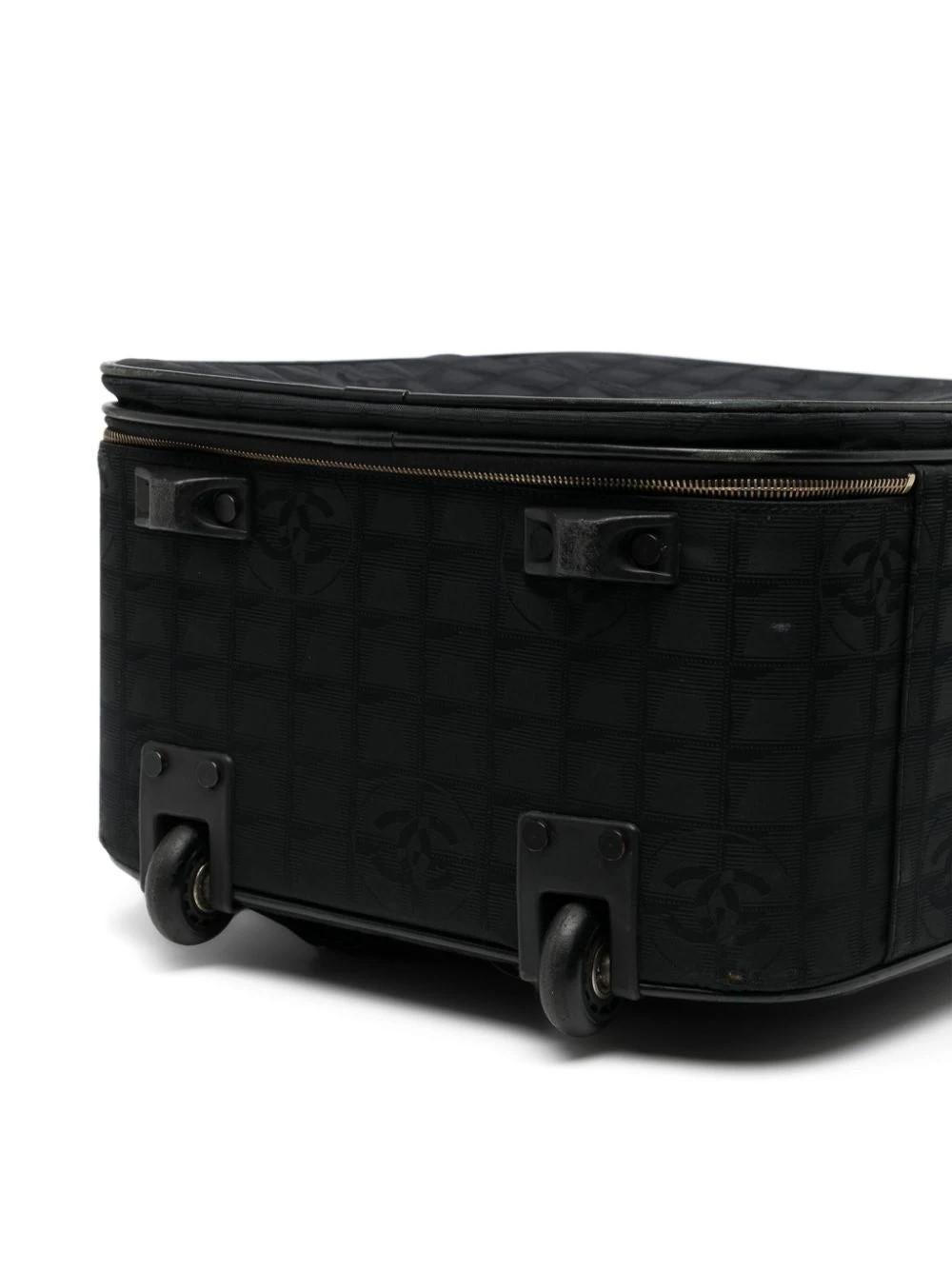 This black-navy travel bag from Chanel is the perfect addition to any journey. The stylish luggage features the iconic brand's logo and includes an authenticity card. While there may be some minor scratches, its durable construction ensures your