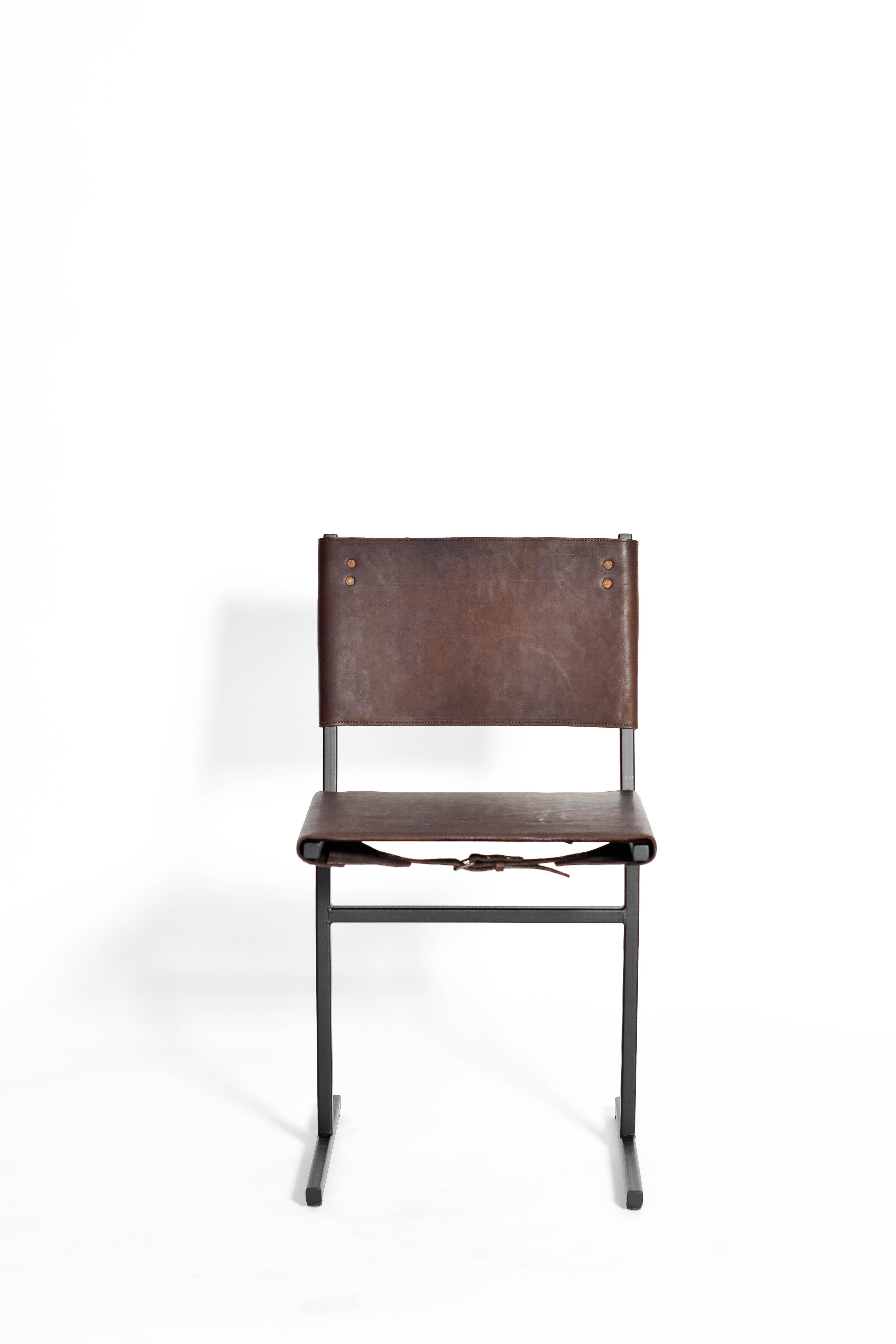 Chocolate and black Memento chair, Jesse Sanderson
Original signed chair by Jesse Sanderson
Materials: Leather, steel
Dimensions: W 43 x D 50 x H 80 cm 
 Seating height: 47 cm.

  

Five lines and a circle – the human body can be as simple