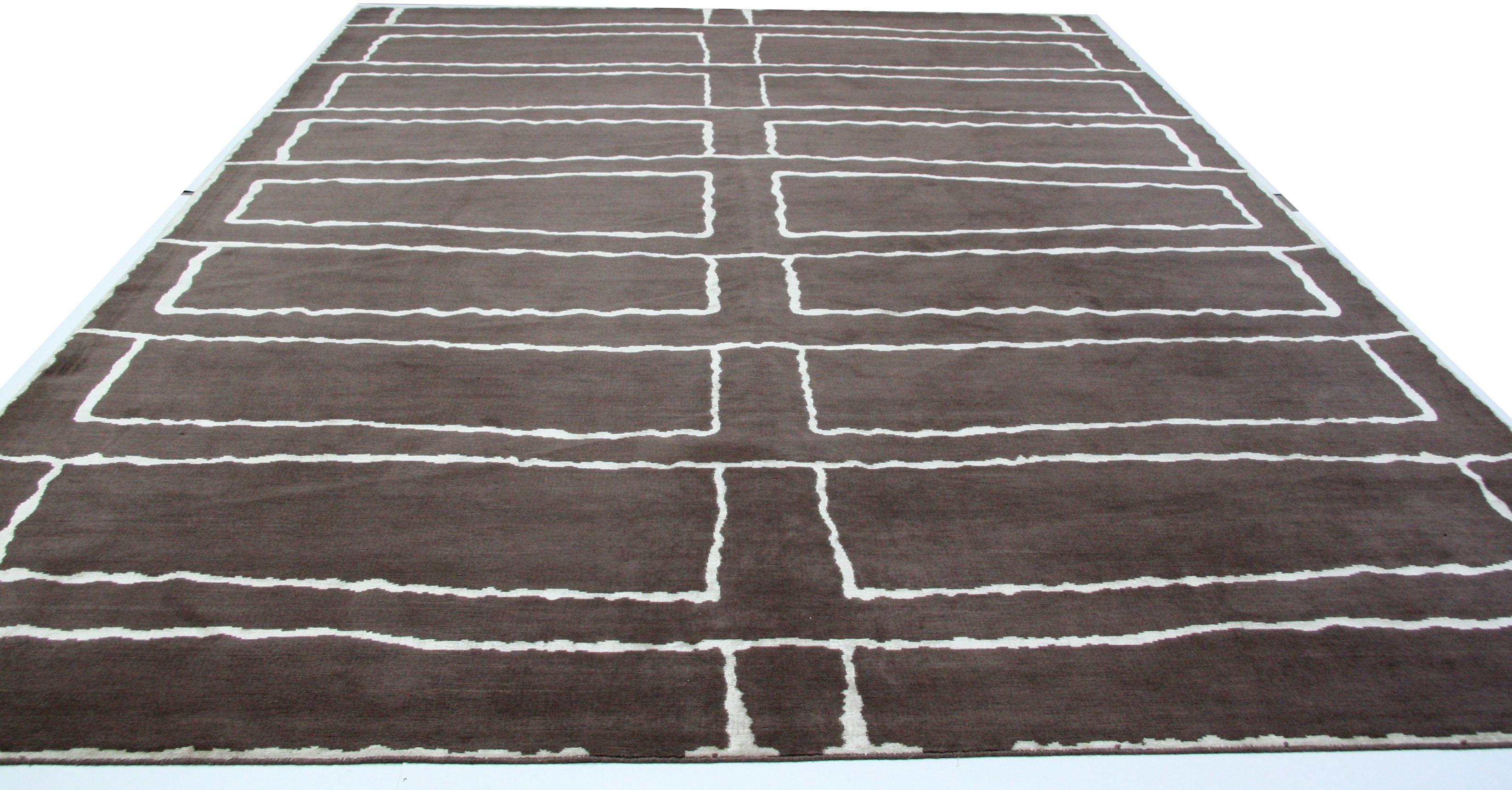 A contemporary line drawing is the inspiration for this dark brown and cream area rug. An excellent companion piece to the modern art-filled home or office space. 

Wool/Silk. Made in India using natural vegetal dyes. 

Also available in