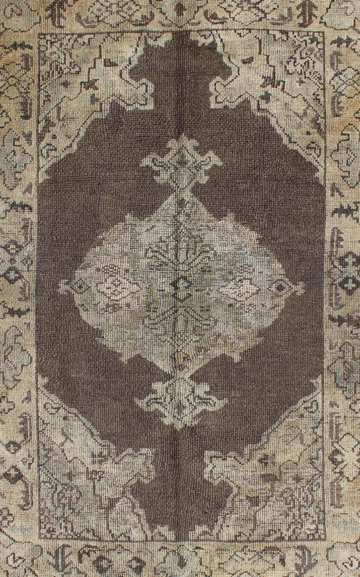 Chocolate Background Vintage Turkish Oushak Rug with Floral Medallion in Cream In Good Condition For Sale In Atlanta, GA