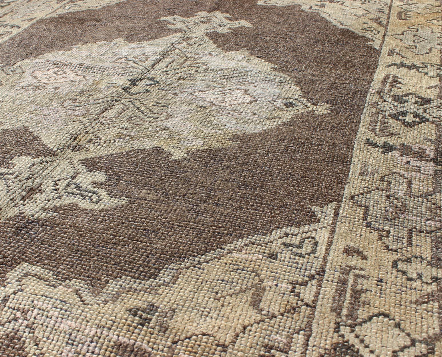 20th Century Chocolate Background Vintage Turkish Oushak Rug with Floral Medallion in Cream For Sale