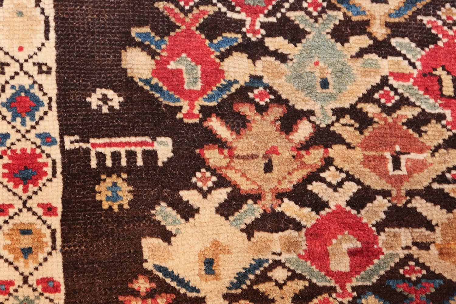 Beautiful and fascinating chocolate brown background antique tribal Caucasian Kuba rug, country of origin / Rug type: Caucasian rug, date circa 1900. Size: 4 ft x 10 ft 2 in (1.22 m x 3.1 m). 

This magnificent and primitive tribal antique Caucasian