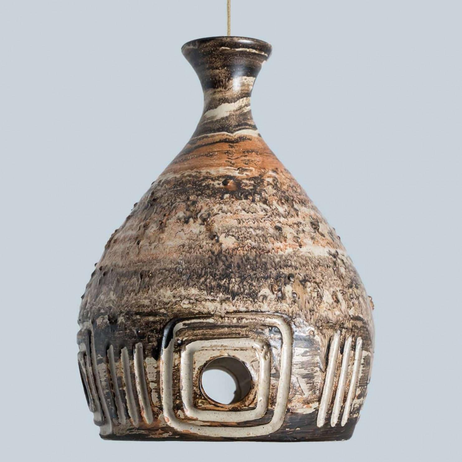 Suspension élégante en céramique fabriquée au Danemark. La lampe est fabriquée en céramique de couleur marron et beige et présente un motif géométrique avec des trous, ce qui crée un bel éclairage.

Une pièce unique dans la pièce.

Nettoyé, bien