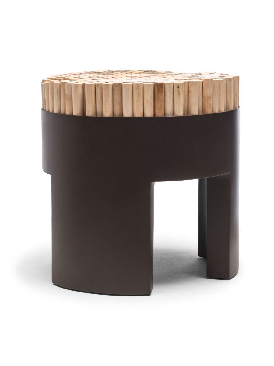 Chiquita chocolate brown stool by Kenneth Cobonpue.
Materials: Rattan, Polyurethane foam, steel. 
Dimensions: Diameter 45 cm x height 46cm. 

Chiquita is a bundle of charms with its clever design and functionality. The Chiquita stool’s vertical