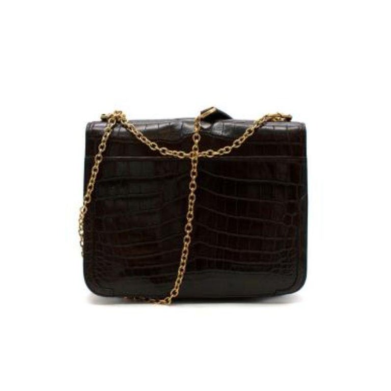 Oscar de la Renta Chocolate Brown Crocodile Flap Bag
 
 - Chocolate brown crocodile embossed leather handbag with fold over top
 - Branded gold tone and tortoise shell trigger clasp
 - Gold tone metal chain slide strap with leather strap 
 - Blue