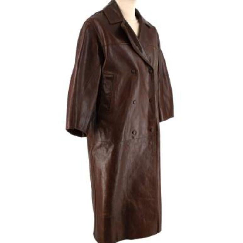 Ganni Chocolate brown longline leather coat
 

 - Cool, louche oversize silhouette
 - Notched lapels, dropped shoulder, and double-breasted fastening 
 - Two functioning diagonal slip pockets 
 - Snap button closure 
 - Satin lined
 

 This item