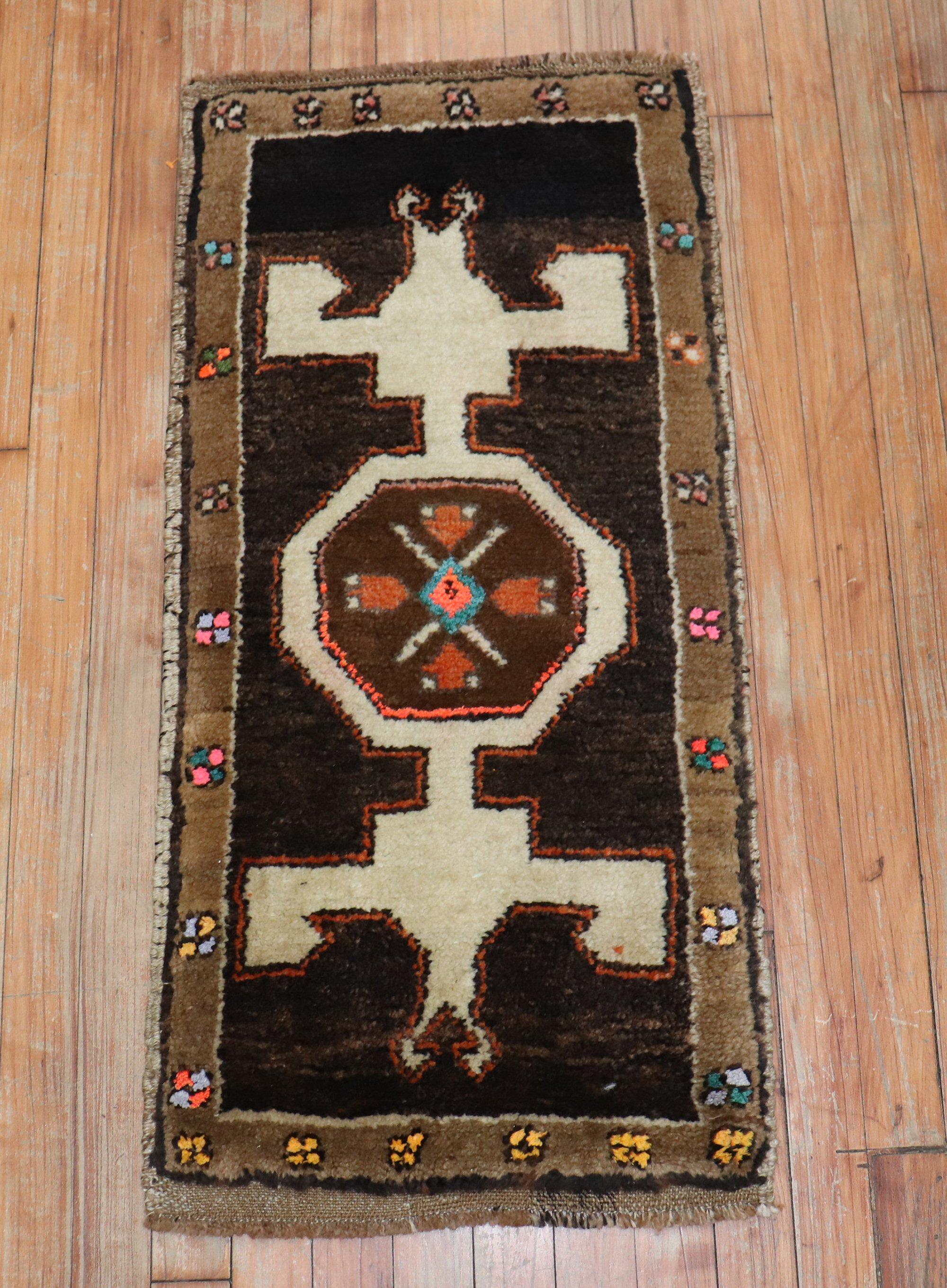 A tribal mid-20th century Turkish mat rug in a predominant chocolate brown color

 Measures: 1'6