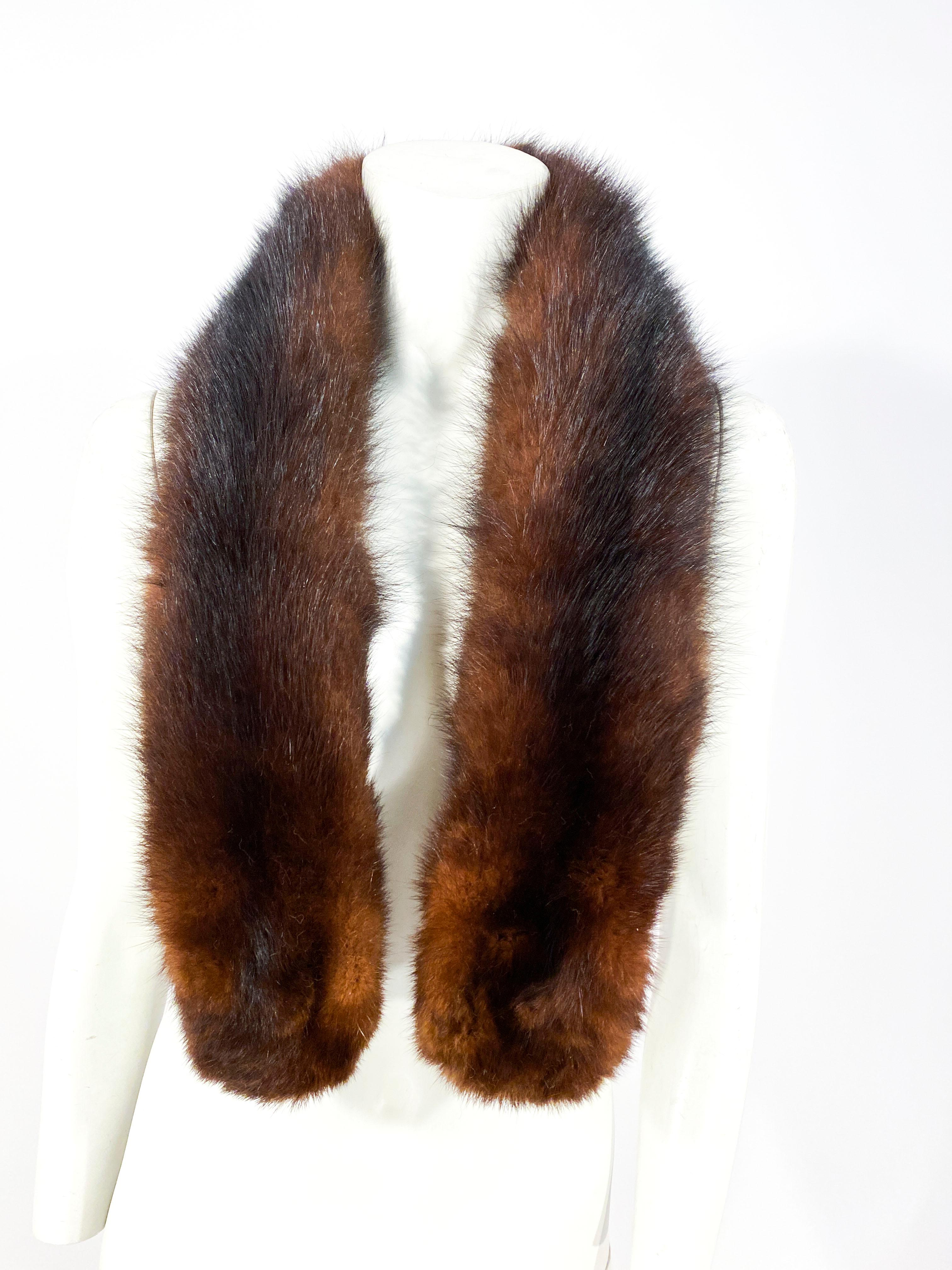 Chocolate brown nutria fur that can be worn as a scarf or a long collar with adjustable closure and a velvet lining.