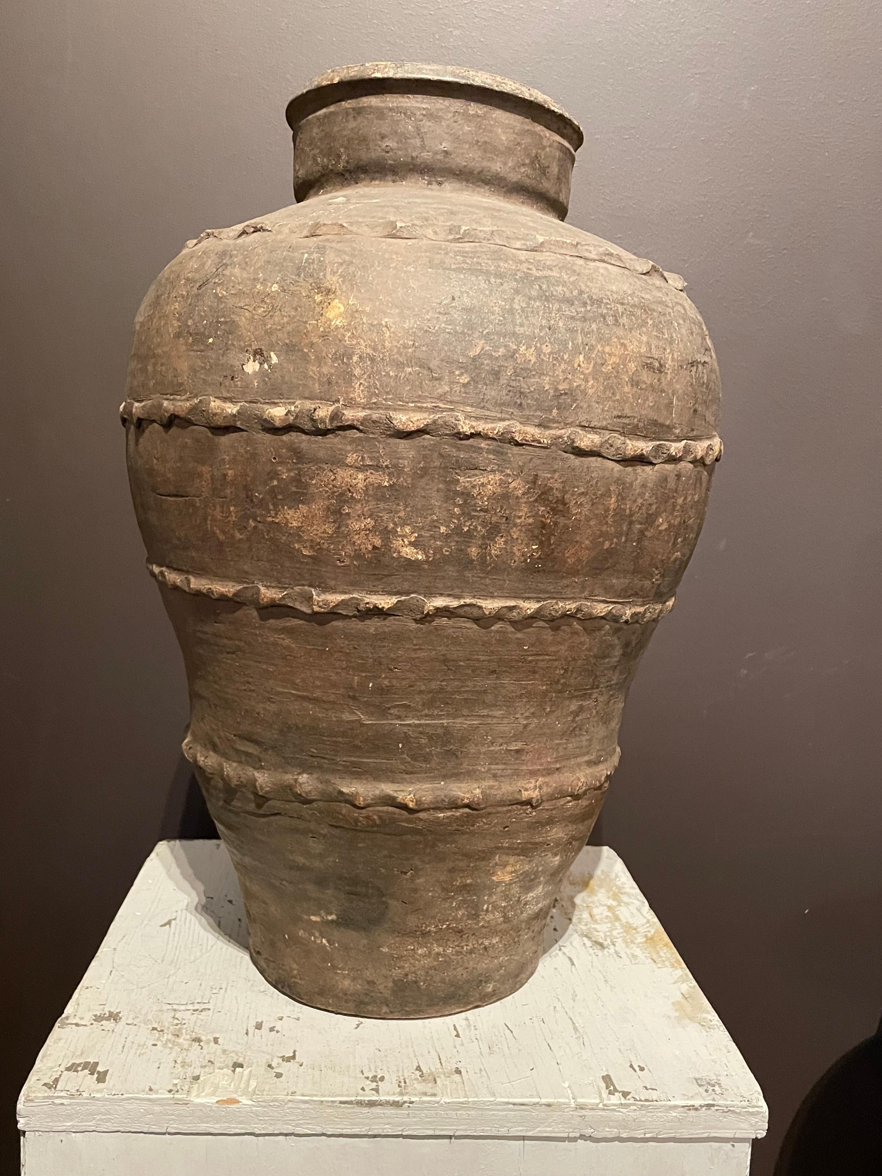 19th century Spanish terracotta olive pot.
Unearthed from a very large family run olive oil producing business in southern Spain.
Chocolate color with raised decorative indented bands.
Beautiful and natural aged patina.
One of many pieces from a