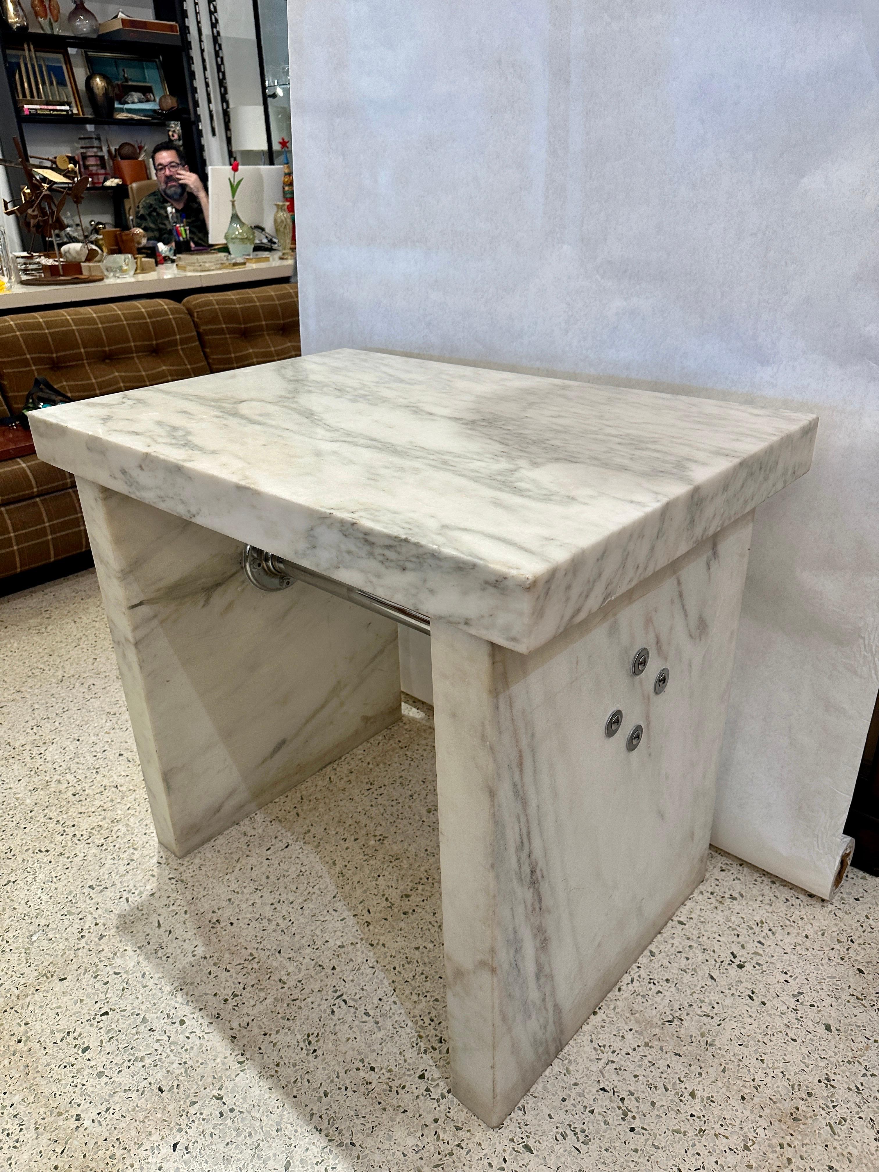This is an original chocolatier/ candymakers marble slab table to cool the chocolate and mold it.  Sourced in Portland, Oregon.  This is comprised of 3 very thick white marble slabs (3 inches thick) with a central chrome stretcher to keep it solidly