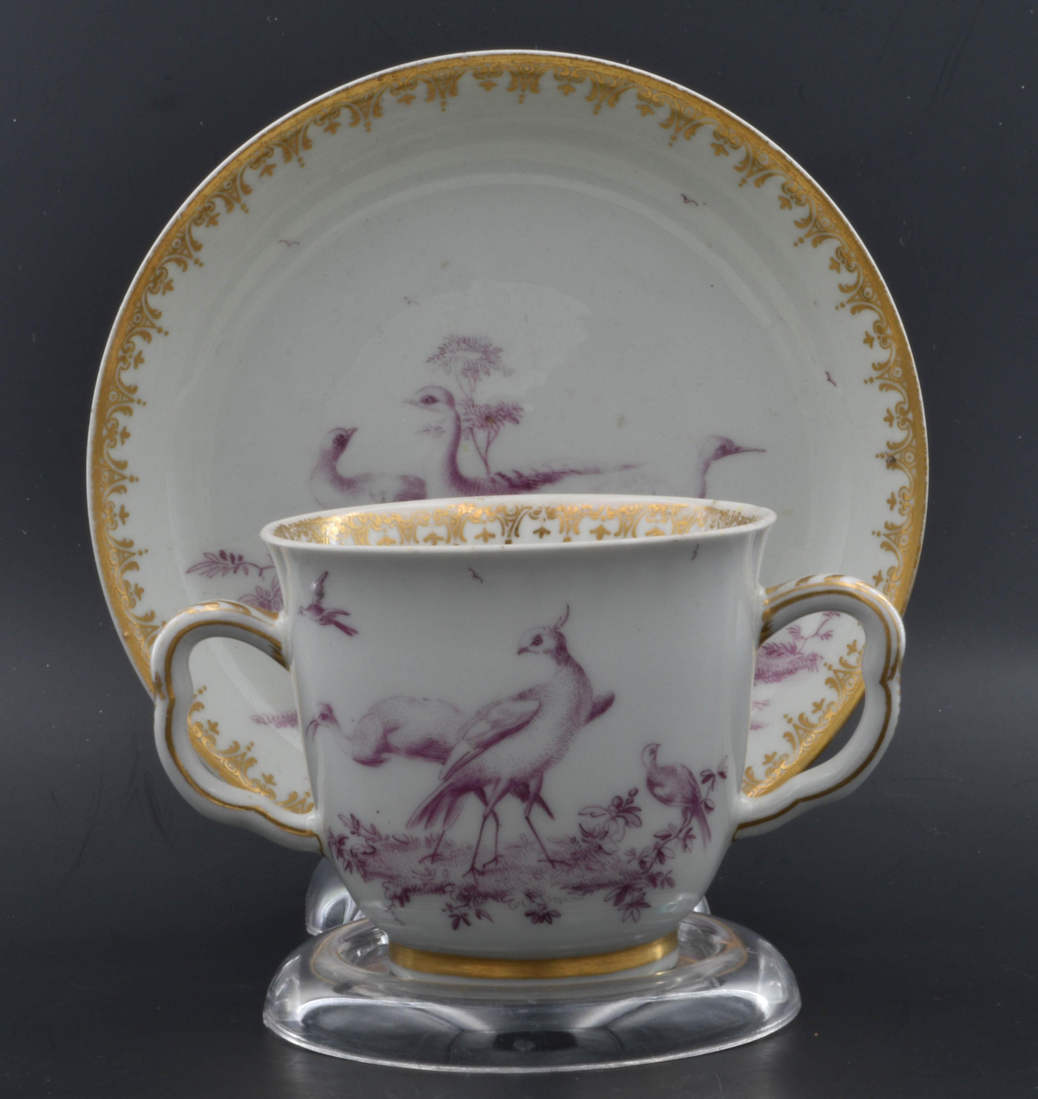 A good chocolate cup, with gilt decoration and finely painted puce birds - so finely painted you might mistake it for a print.