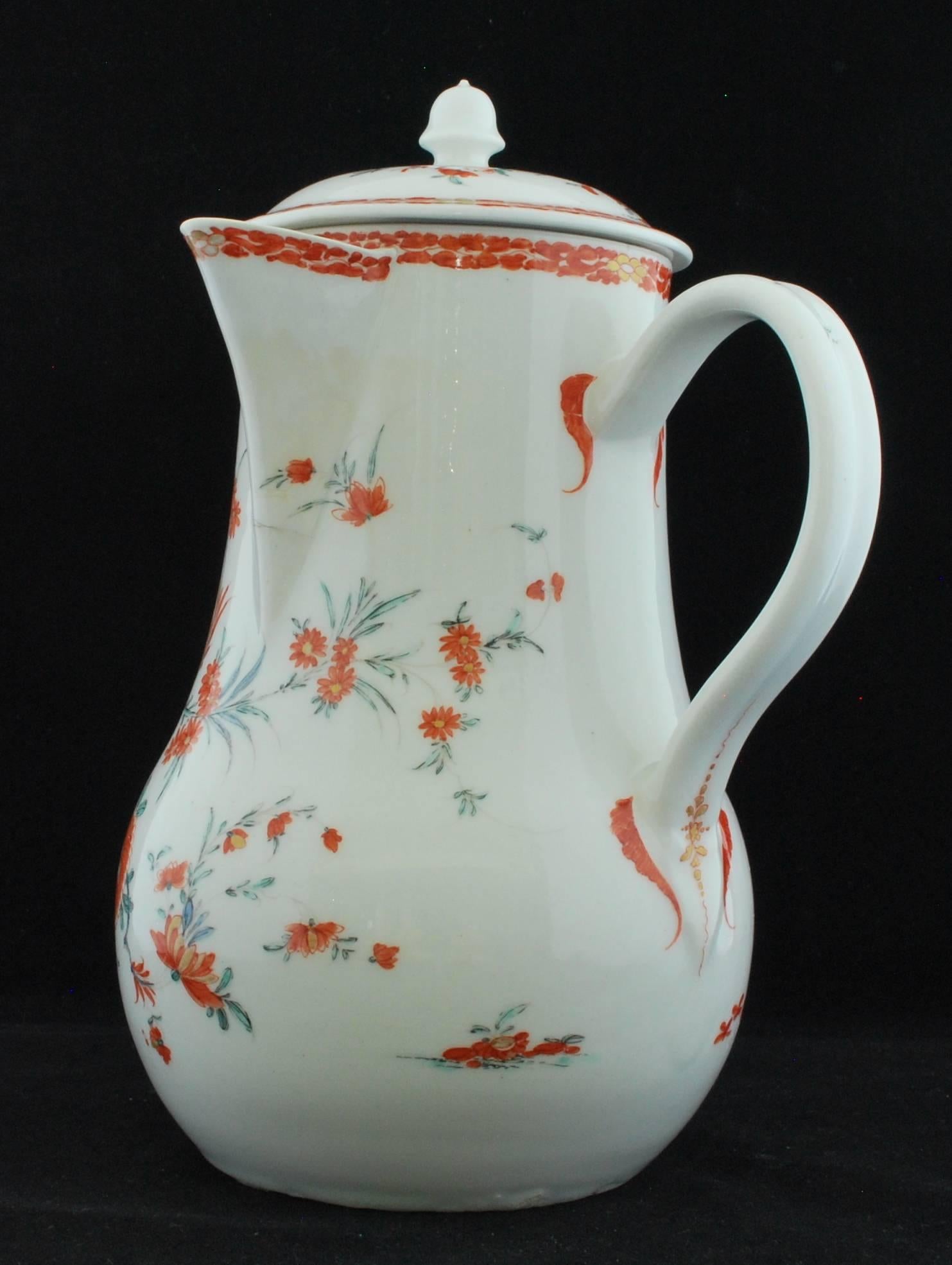 Of full-bellied pear-shape with large sparrow-beak lip set slightly below the top rim of the body in front of a triangle of circular pouring holes and at the right angle to the strap handle. Charming decoration after the Kakiemon.

Provenance: