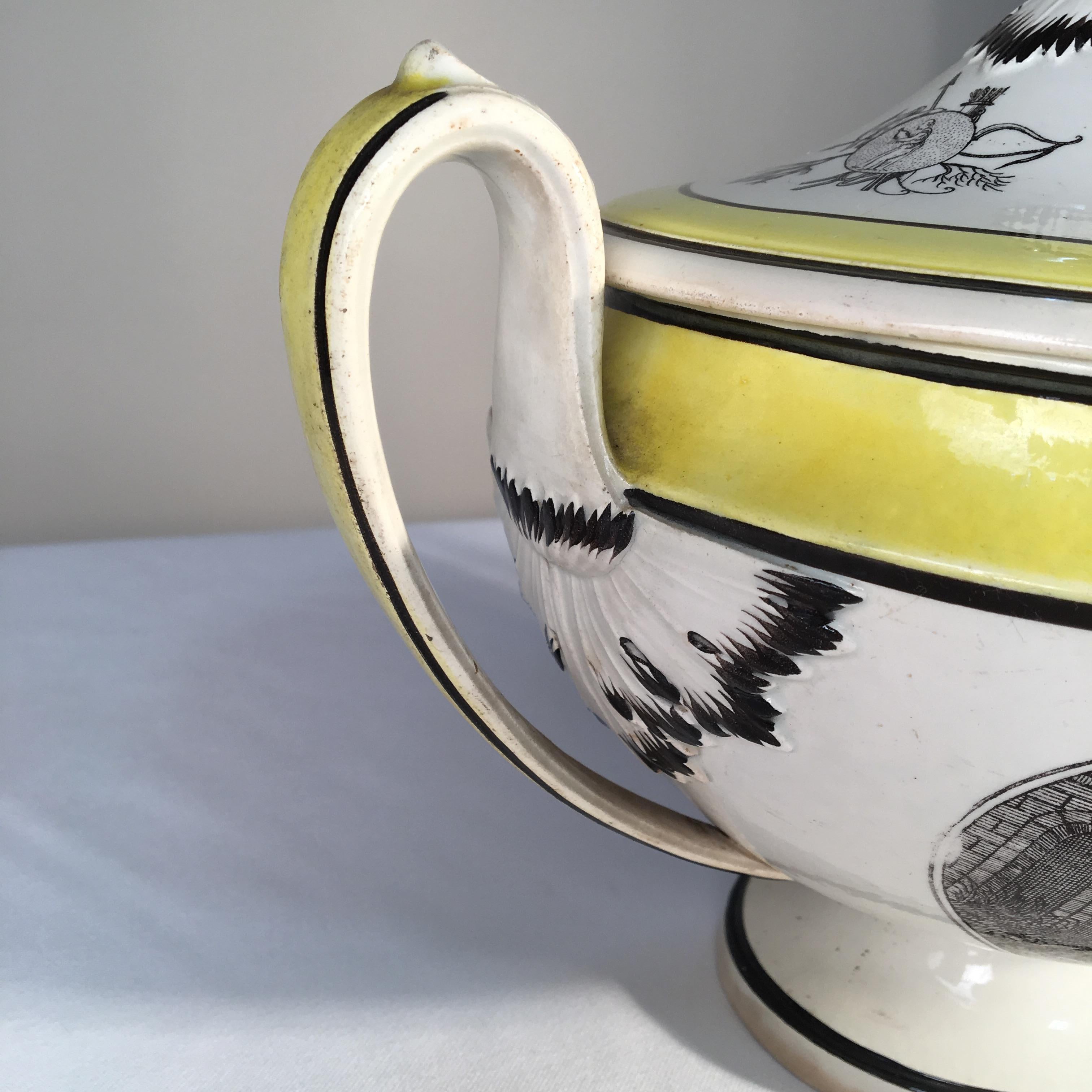 An early 19th century French Empire soup tureen signed Choisy, circa 1810, footed-urn shaped with looping handles and retaining its original lid with finial. The tureen has transfer decoration depicting military figures in a landscape and has yellow