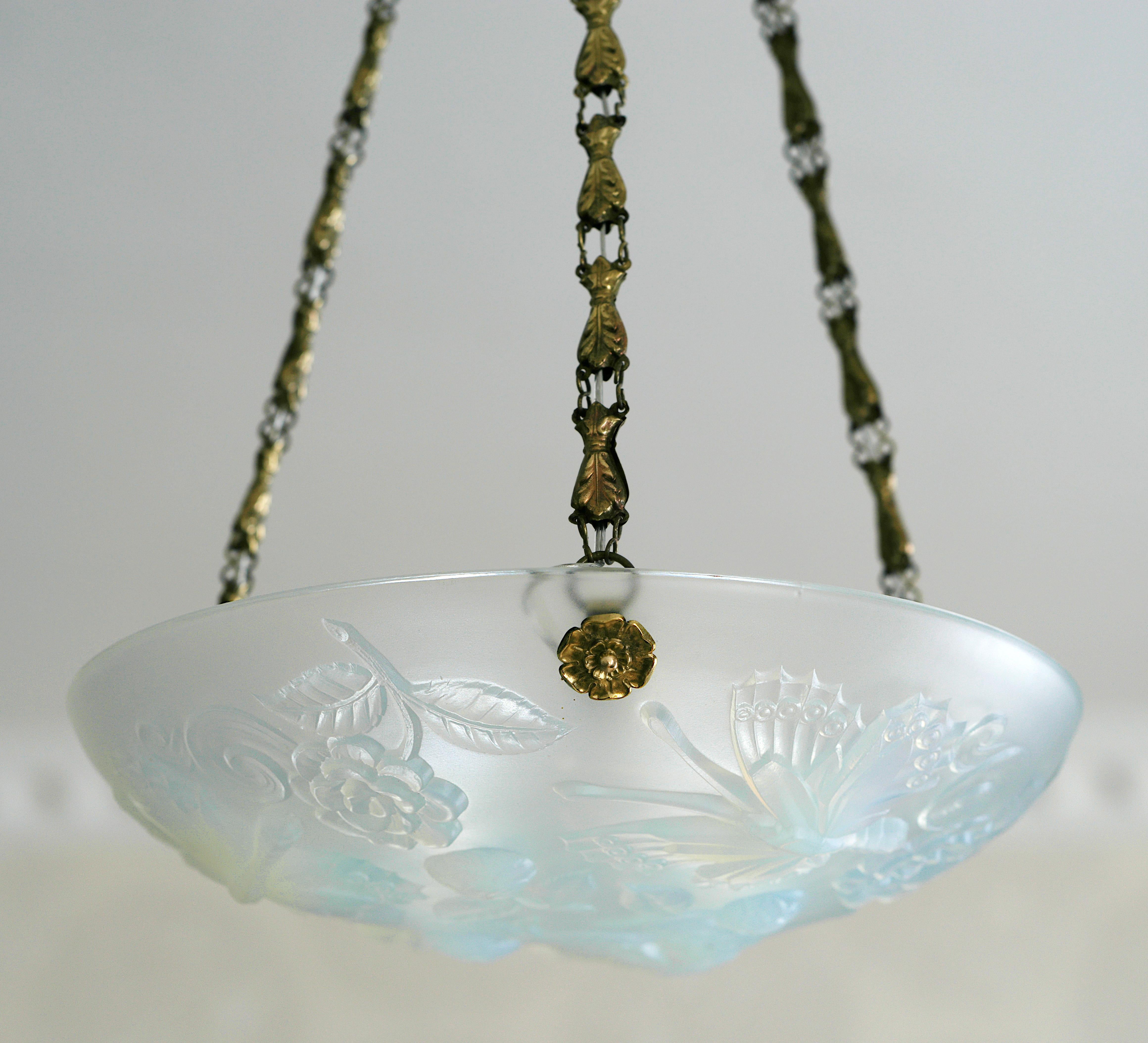 French Art Deco butterly pendant chandelier by Choisy-le-Roi (Paris), France, 1920s. Thick opalescent molded glass hung at its period stamped brass fixture. Measures: Height: 25