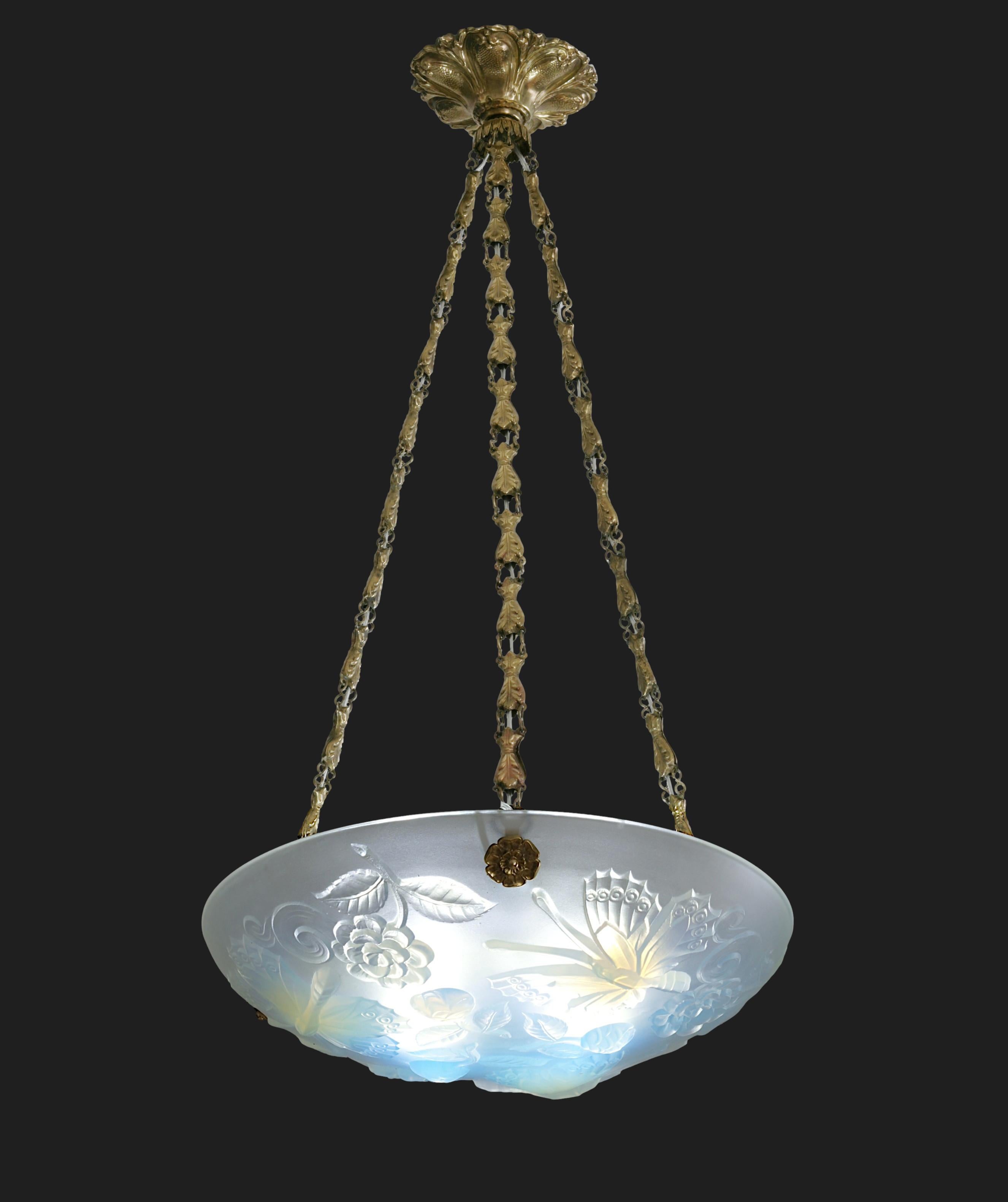 French Art Deco butterly pendant chandelier by Choisy-le-Roi (Paris), France, 1930s. Thick opalescent molded glass hung at its period stamped brass fixture. Measures: Height: 25