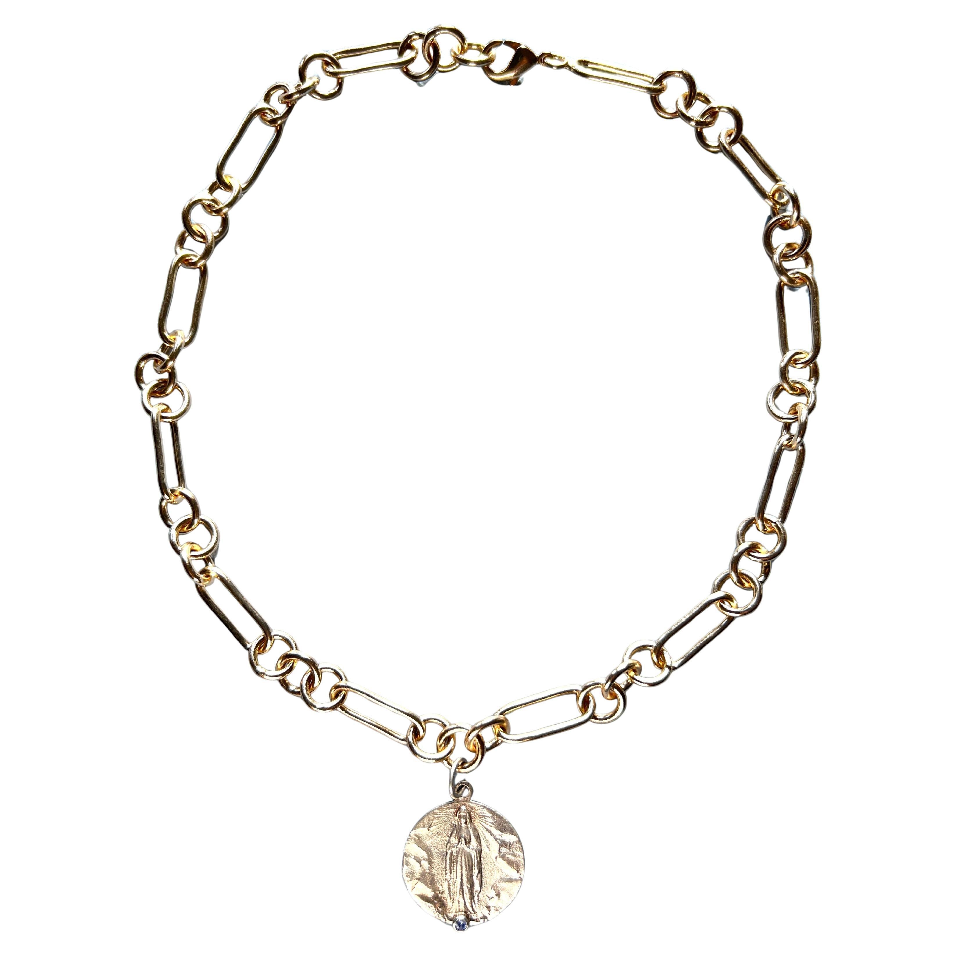 Choker Necklace Medal Virgin Mary Tanzanite

This Necklace is a 14k Goldplated Brass Chain with a silver medal featuring Virgin Mary, It has a Tanzanite on the front. Tanzanites are said to be helping with your third eye, and open up your psychic