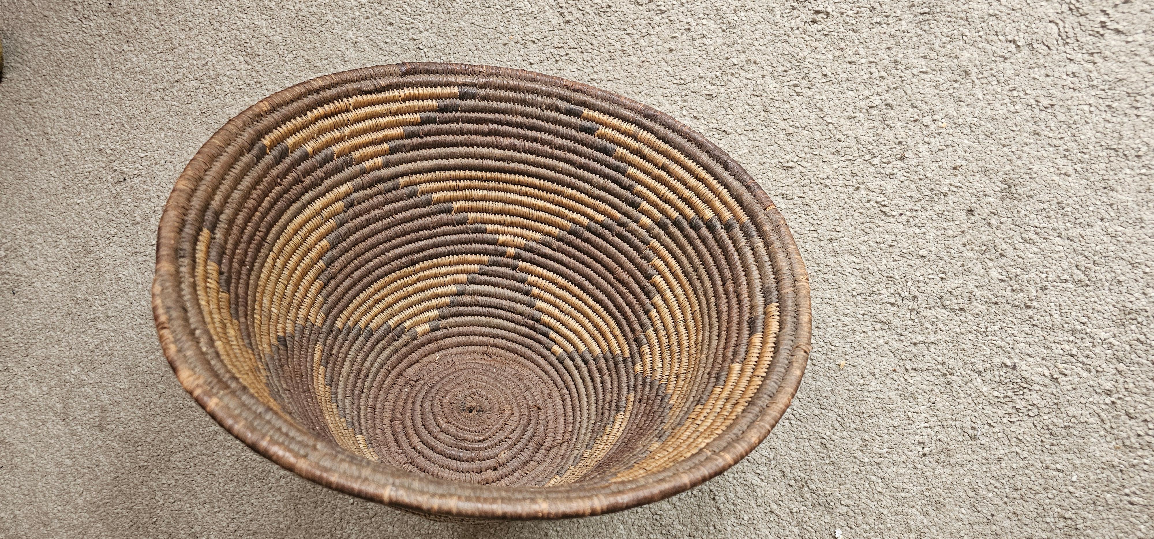 This is a beautiful  presentation basket from the Chokwe people of Angloa . Woven tightly from strong rafia strands and diamond motifs only used for  high ranking insignia . 
The basket would have been used to present and carry the  Chiefs wives
