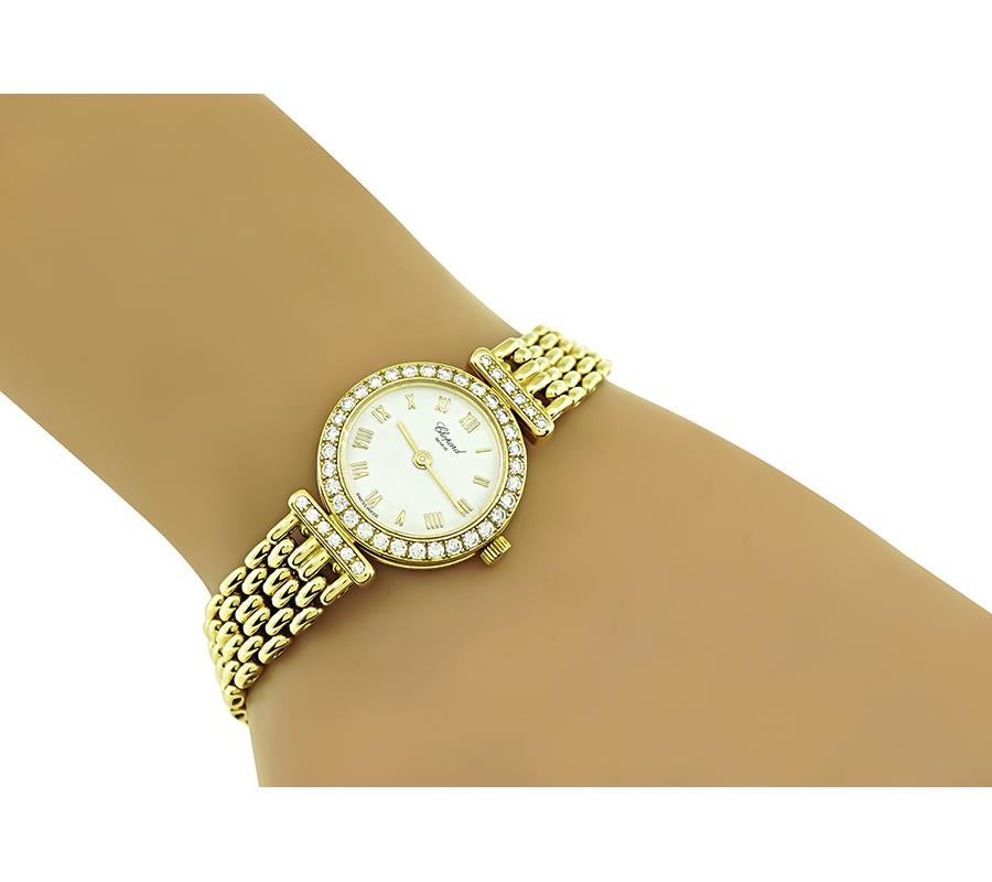This is a charming Chopard diamond 18k yellow gold lady's watch. The watch features sparkling round cut diamonds that weigh approximately 0.80ct. The color of the diamonds is F with VS clarity. The dial is signed Chopard Geneve. The band of the